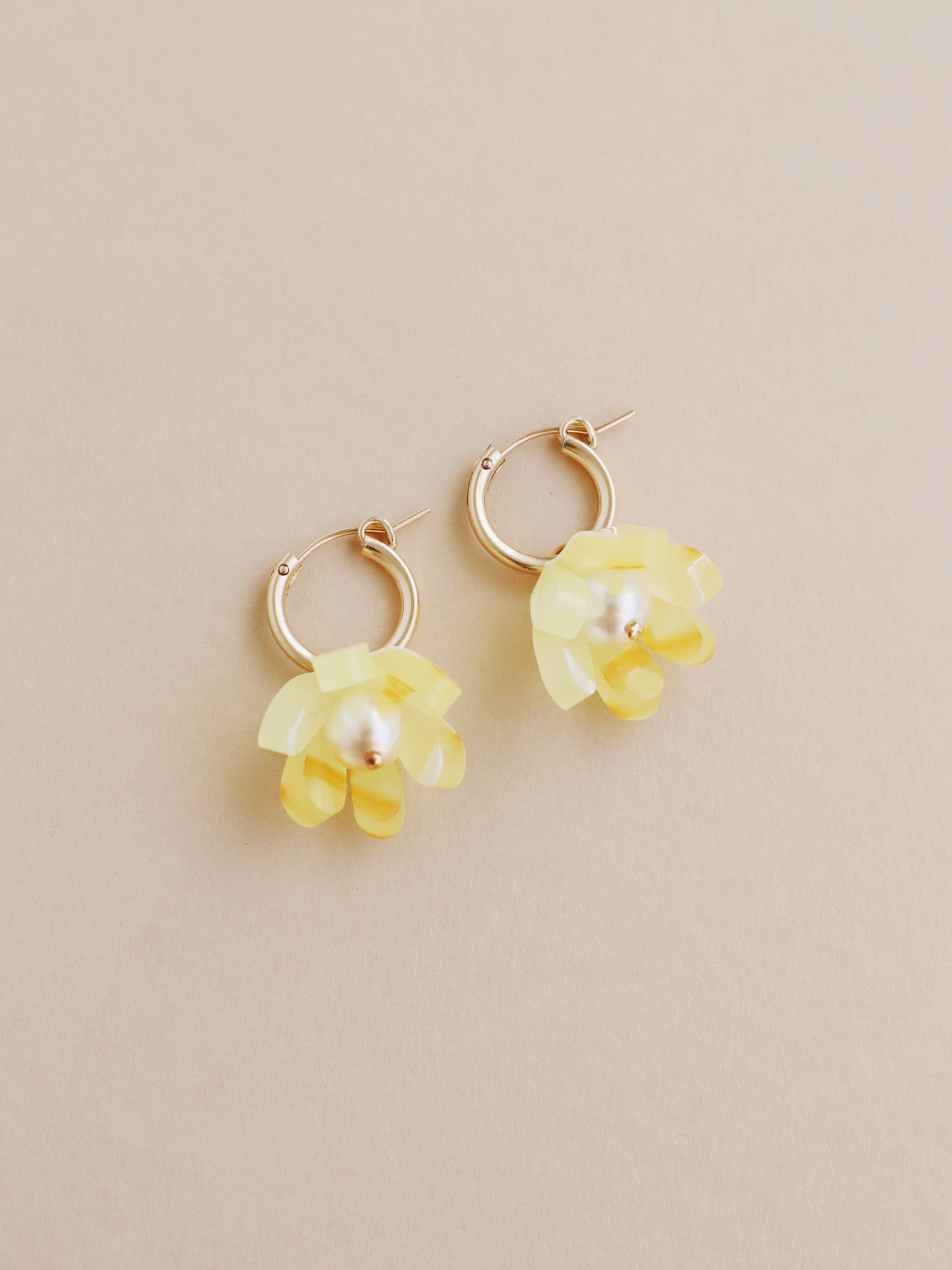 Yellow, sculptural tulip hoop earrings. Made from heat-formed acrylic with high quality glass pearls and 14k gold-filled findings. Handmade in the UK by Wolf & Moon.