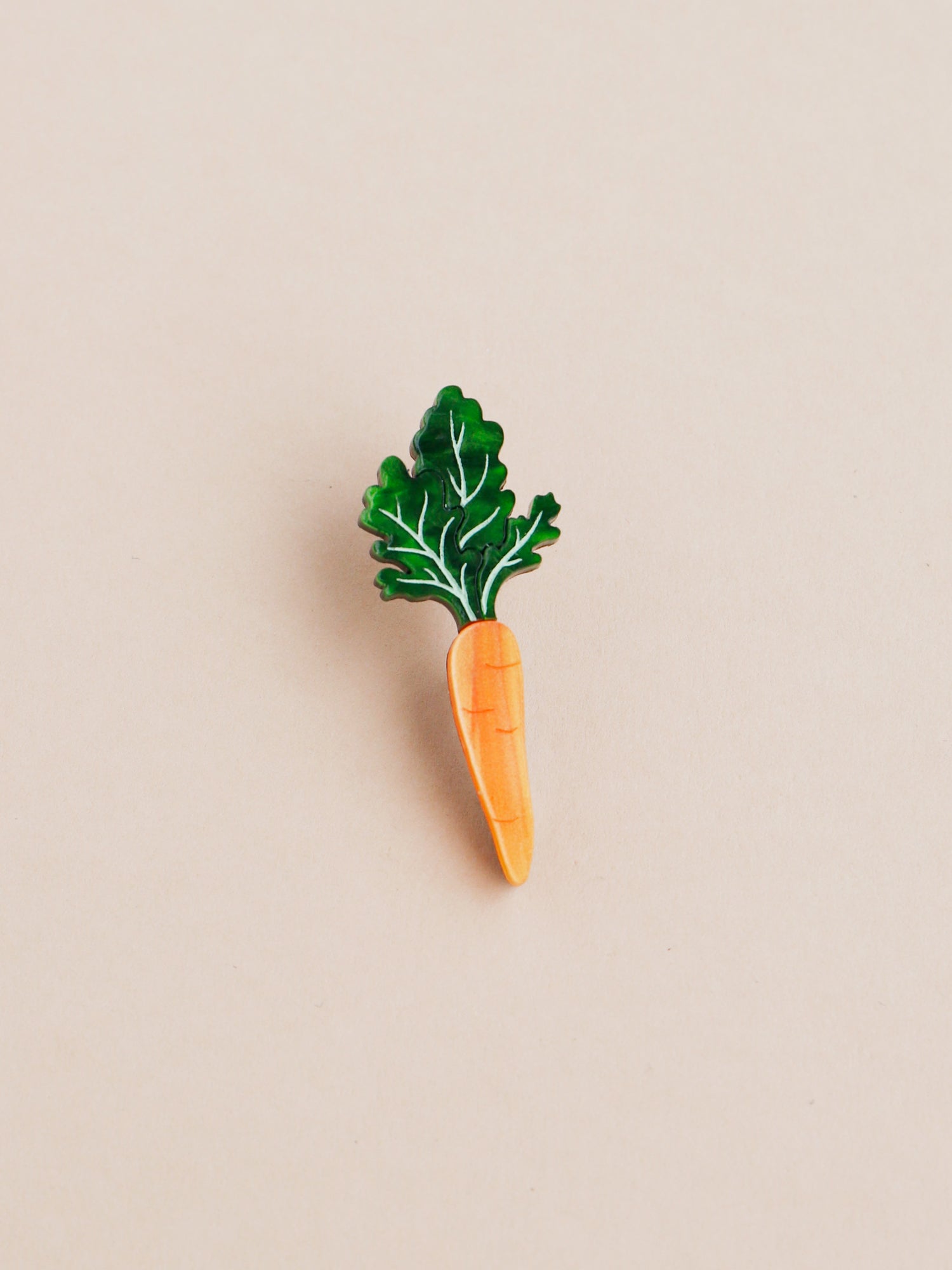Green and orange hand-inked acrylic mini carrot pin. Handmade in London by Wolf & Moon.