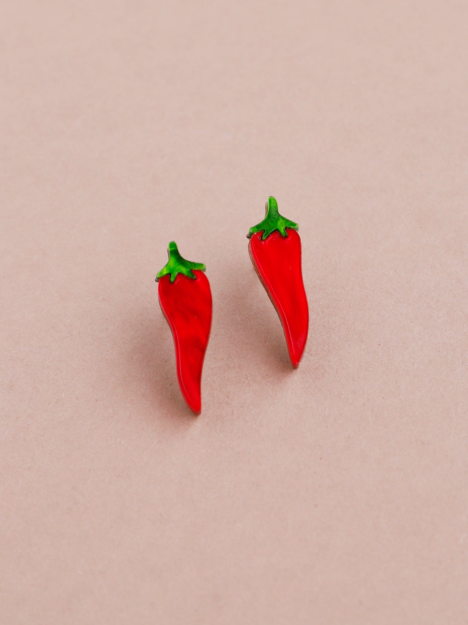Red chilli pepper acrylic studs with green stalk. Handmade in London by Wolf & Moon.
