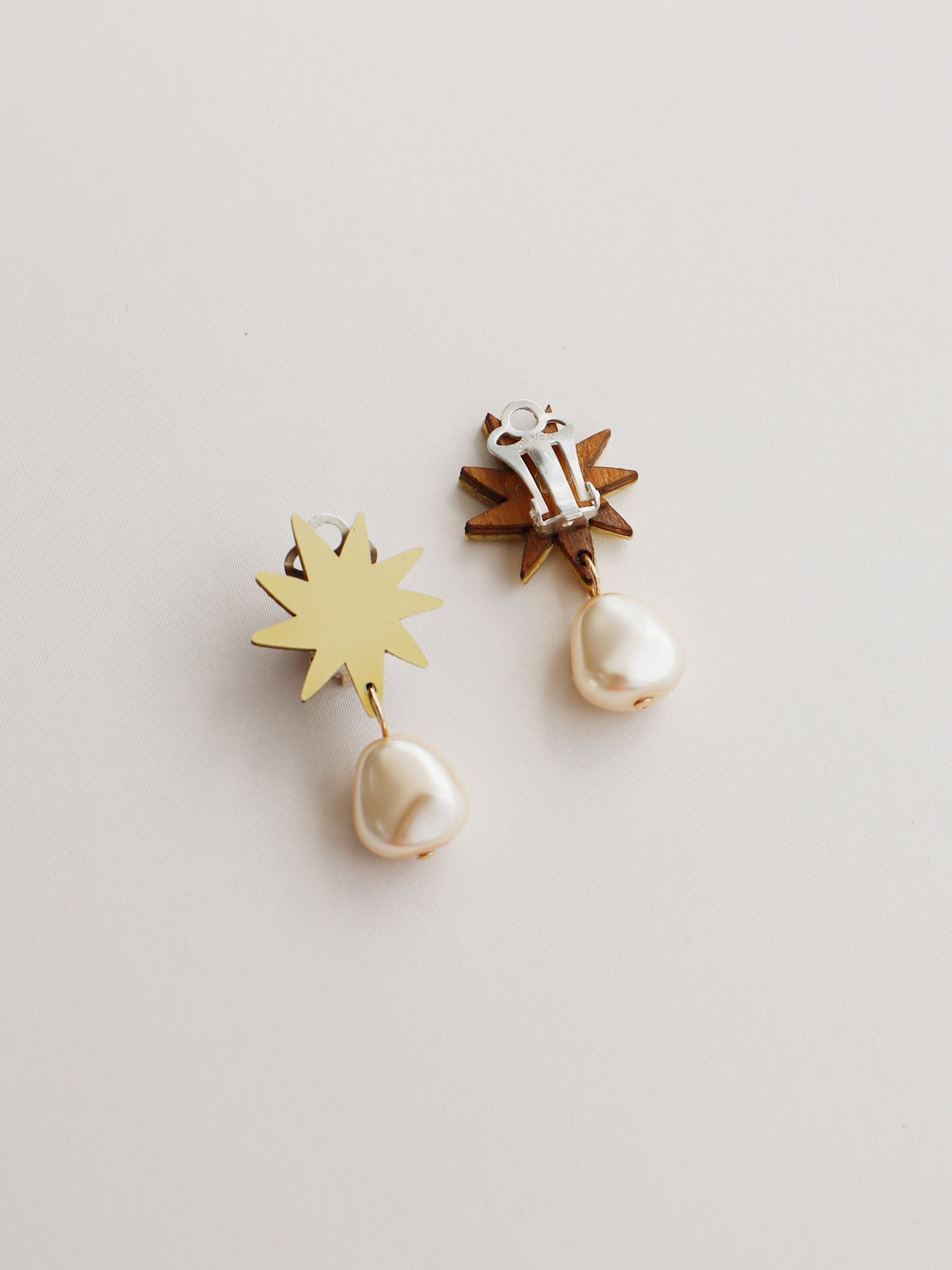 Playful pendant, inspired by Matisse's cutout-style stars. Made in brass with our signature wood base, Czech glass baroque pearl and 14k gold-filled chain. Handmade in the UK by Wolf & Moon.