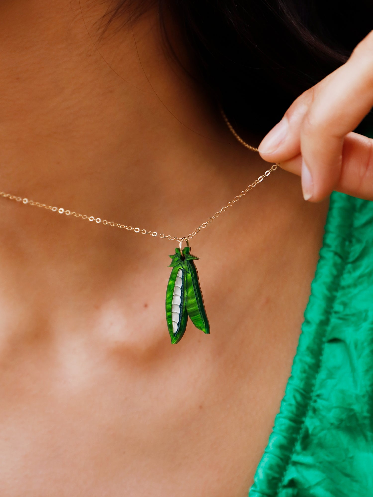 A playful peas in a pod pendant made from marbled acrylic and wood with an optional 14k gold-filled chain. Handmade in London by Wolf & Moon.