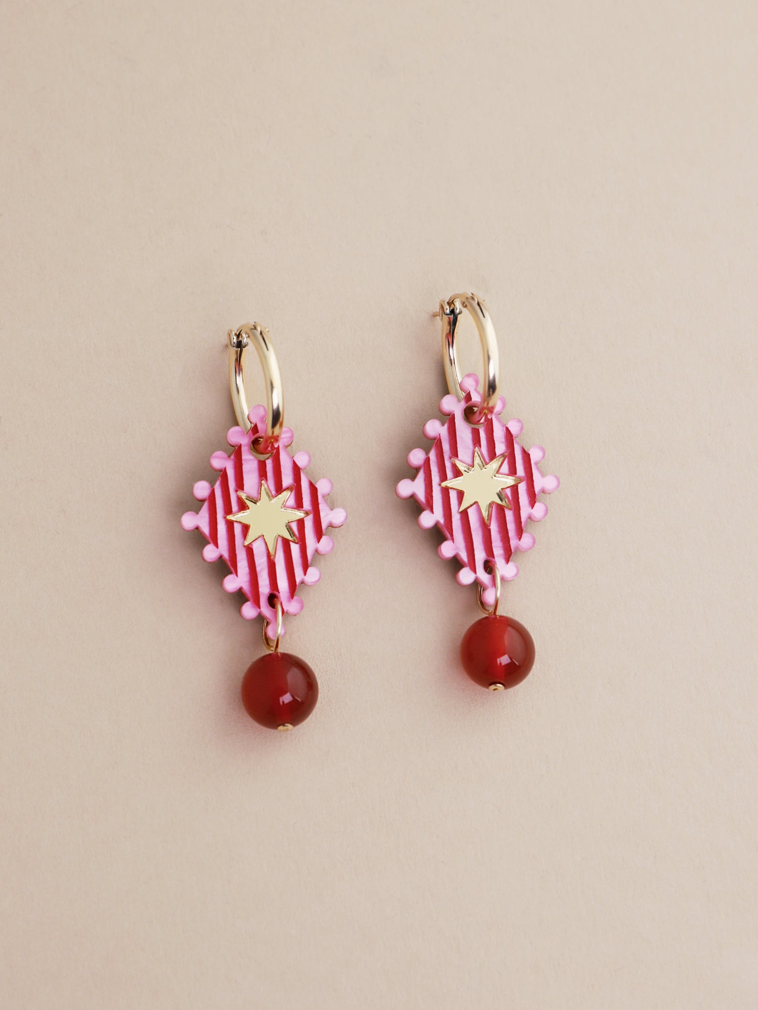 Cirque Hoops in Rose designed by Wolf & Moon, handmade in UK, featuring vibrant pink and red bead details.
