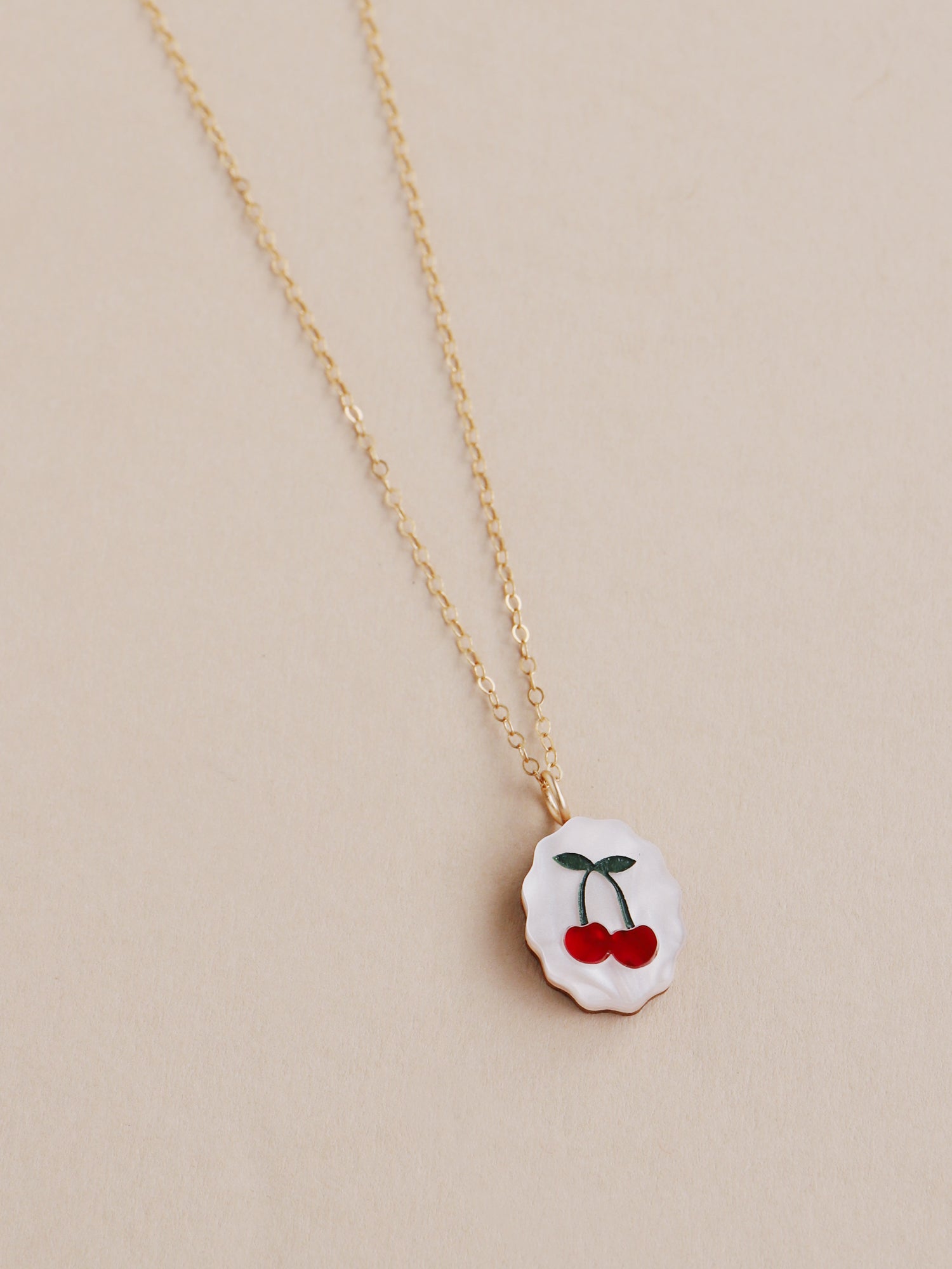 Cherry charm necklace made from acrylic and a 14k gold-filled chain & findings. Handmade in the UK by Wolf & Moon