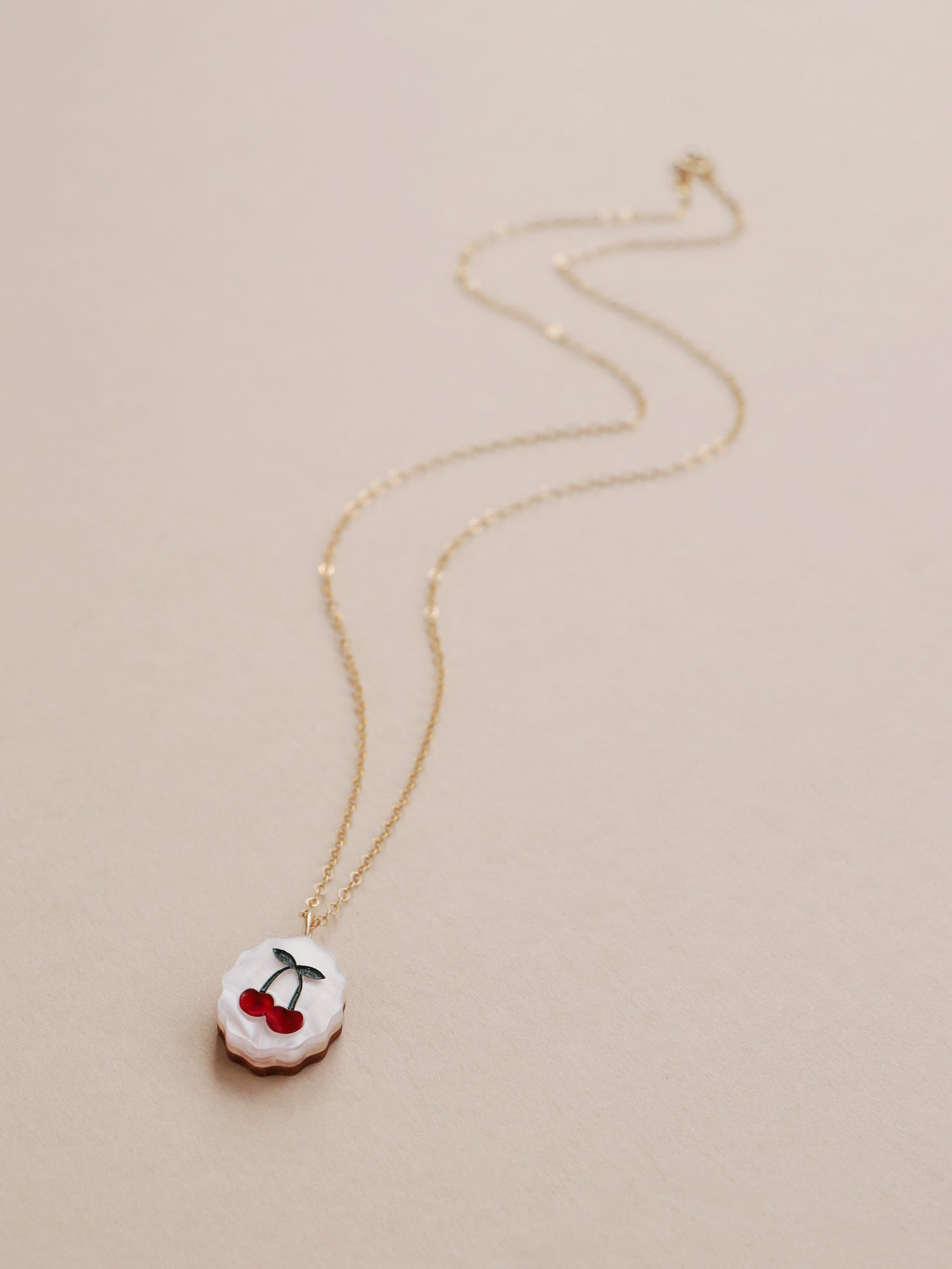 Cherry charm necklace made from acrylic and a 14k gold-filled chain & findings. Handmade in the UK by Wolf & Moon