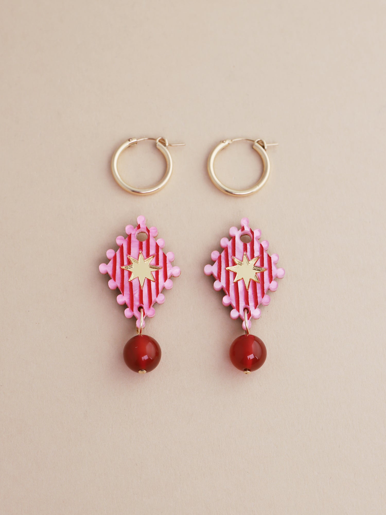 Cirque Hoops in Rose featuring hand-inked details and gold-filled hoops, handmade in UK by Wolf & Moon.