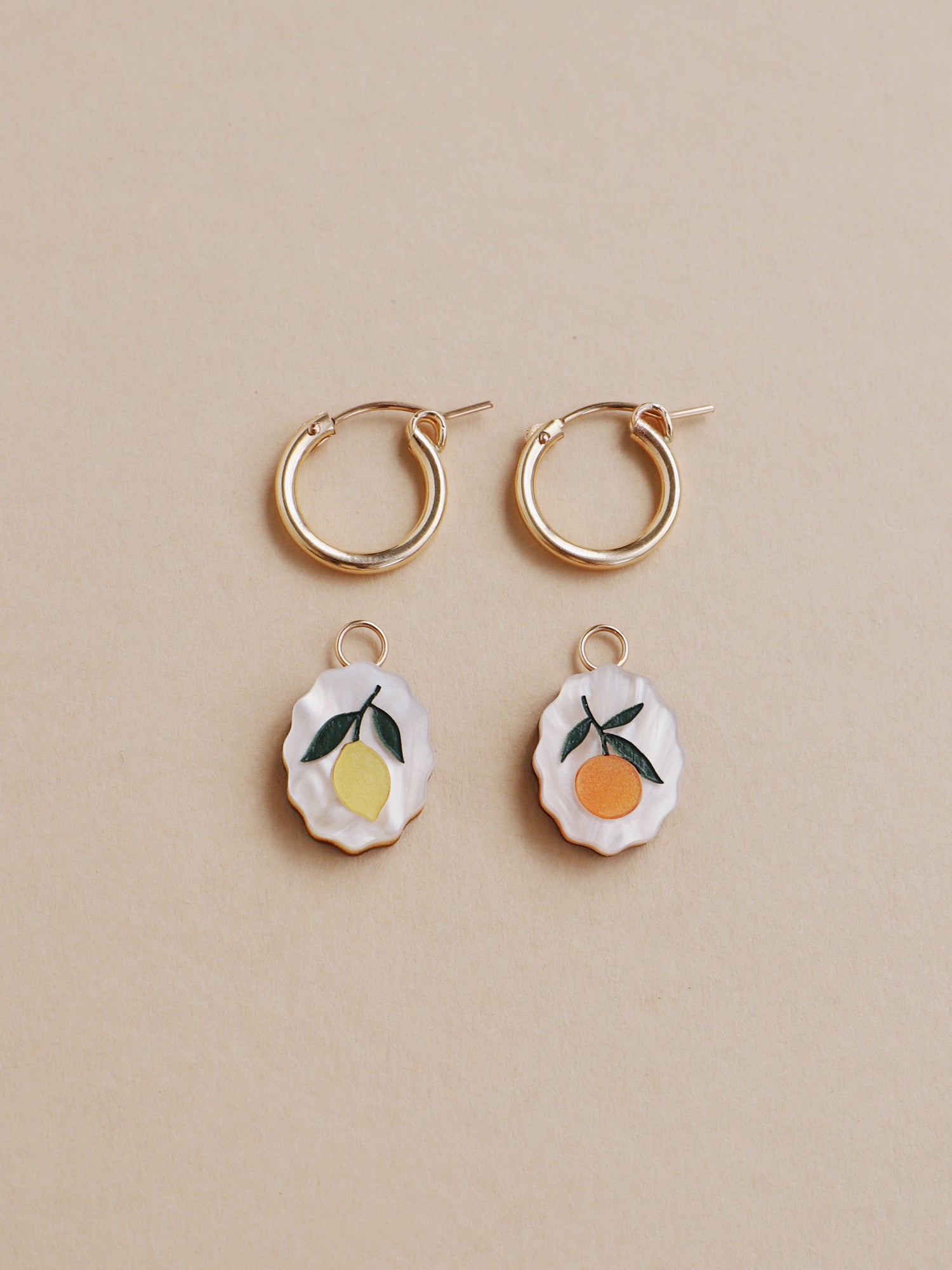 Lemon and orange charm hoop earrings. Made from acrylic and 14k gold-filled hoops & findings.  Handmade in the UK by Wolf & Moon.