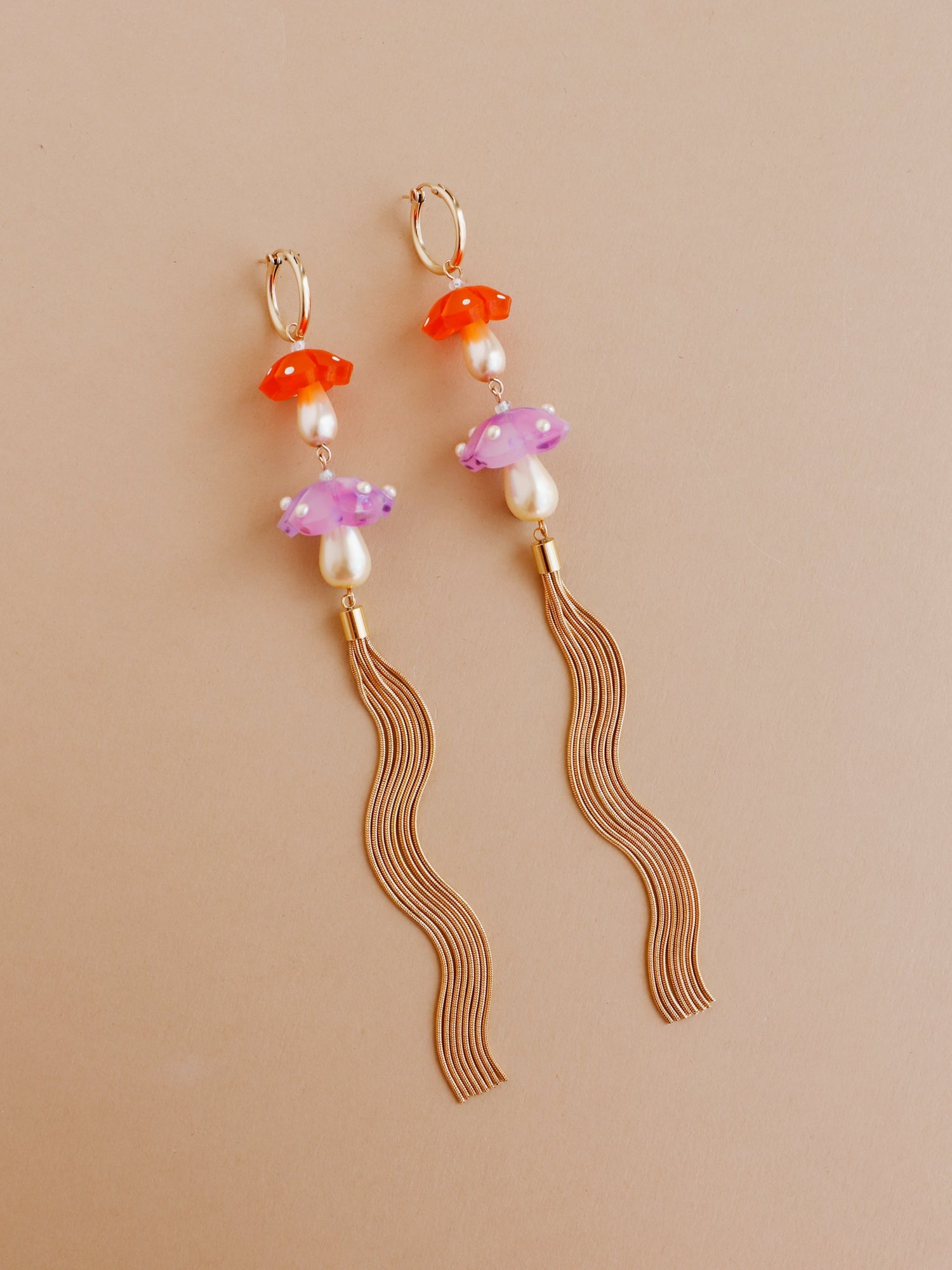 Double mushroom hoop earrings in lavender with snake chain tassels. Made from heat-formed acrylic with hand-inked details and finished off with high quality Czech glass pearls. Handmade in the UK by Wolf & Moon.