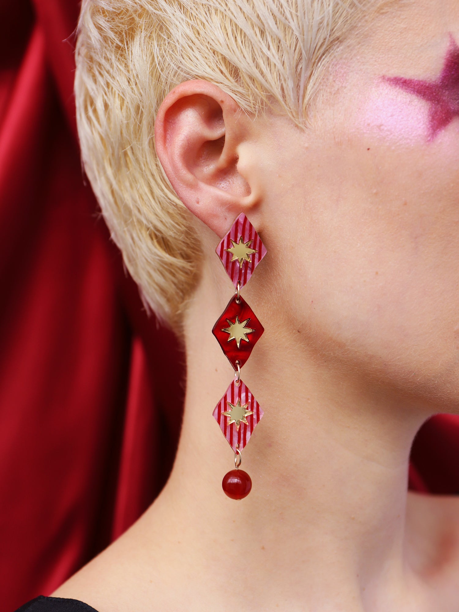 Harley Statement Earrings in Rose displayed on a model with short hair, featuring unique hand-inked details and bead accents.