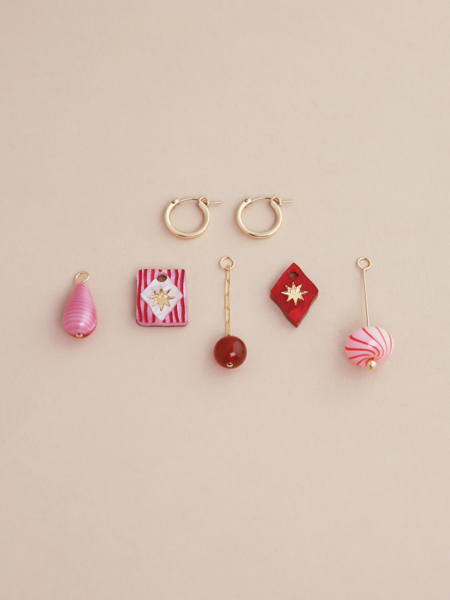 Kaleido Charm Hoops Set in Rose featuring five unique charms, handmade in UK by Wolf & Moon, displayed with gold-filled hoops.