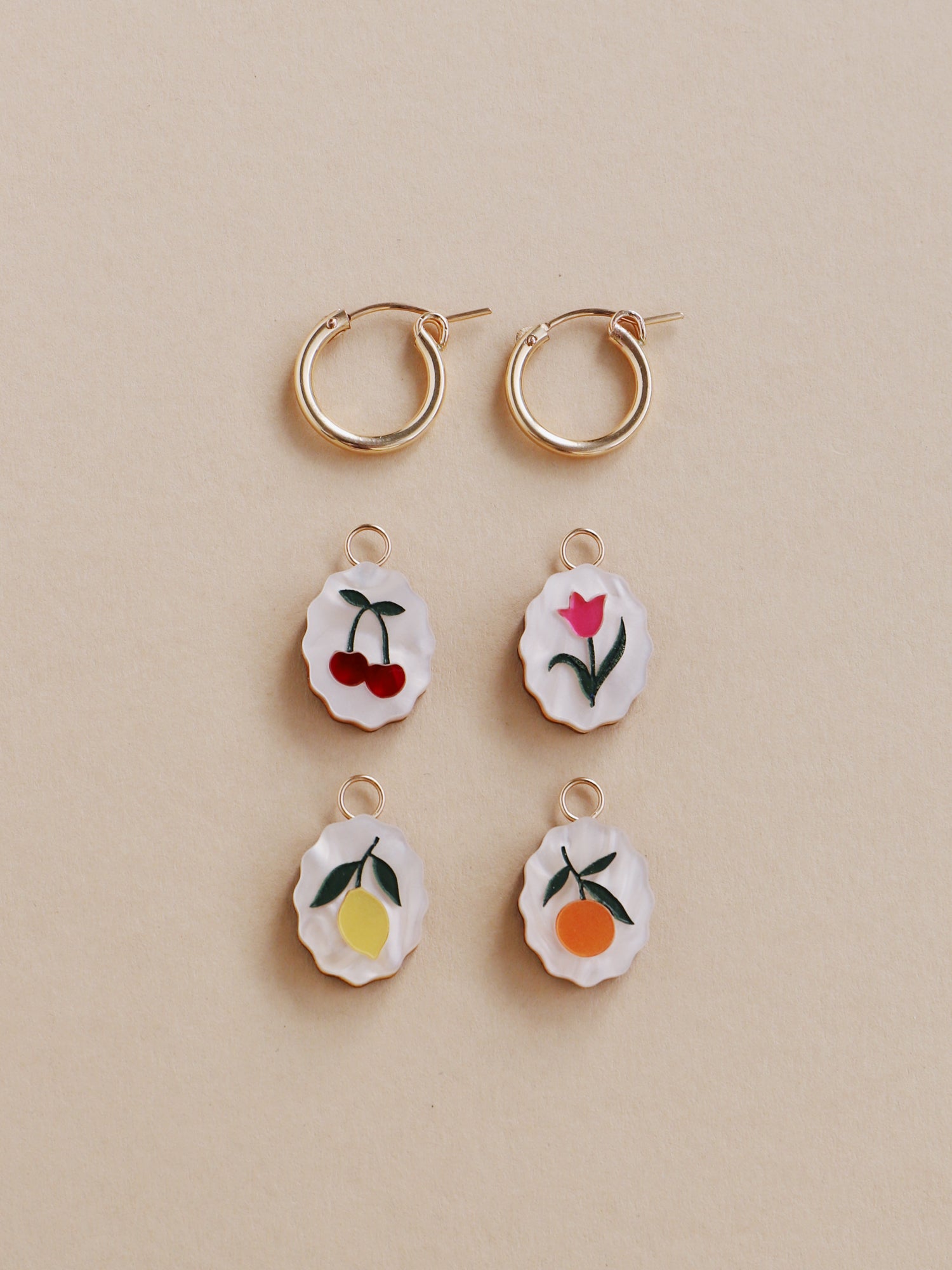 Lemon, cherry, tulip & orange mix n’ match charm hoop earrings. Made from acrylic and 14k gold-filled hoops & findings. Handmade in the UK by Wolf & Moon.