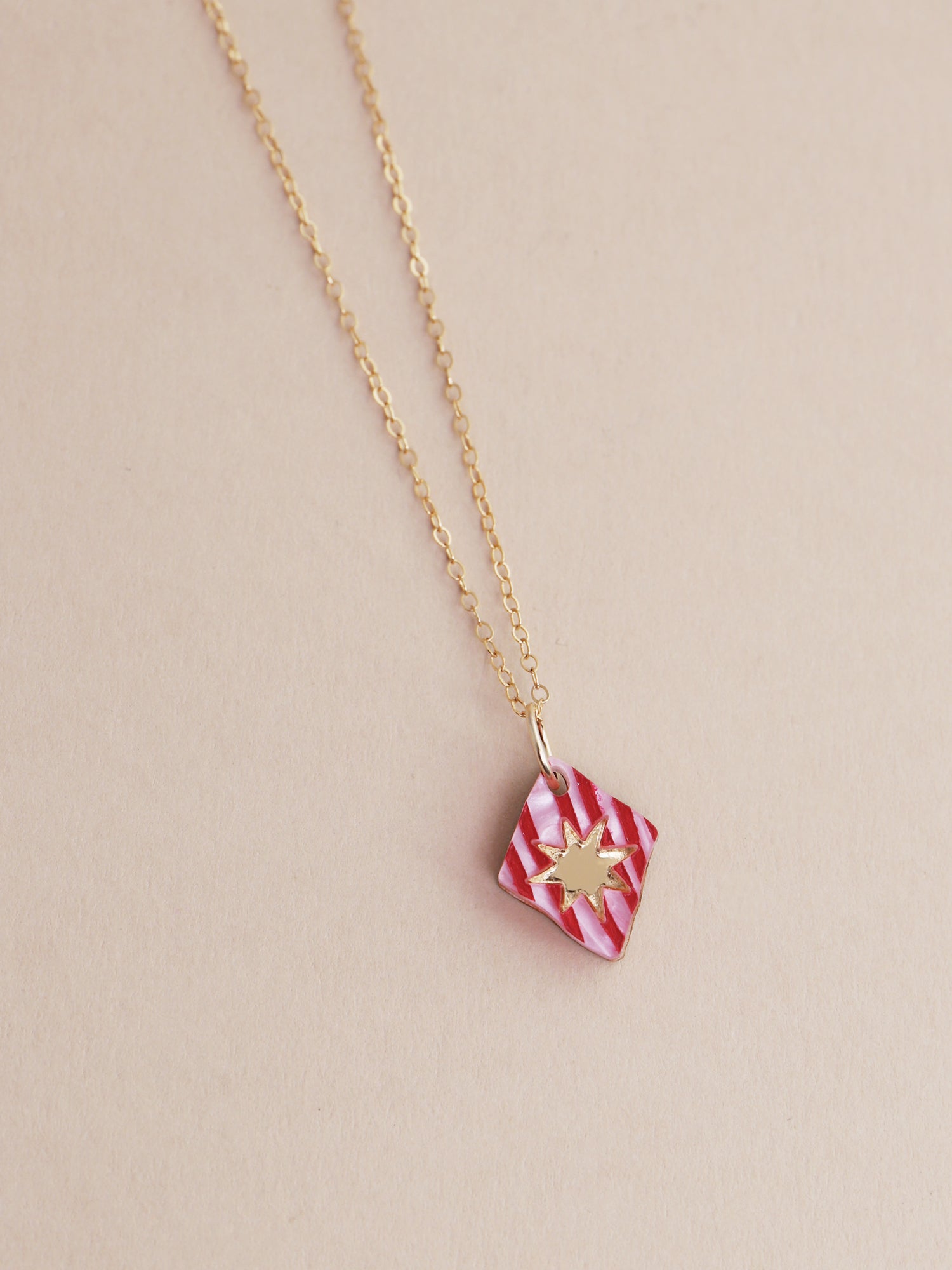 Nova Necklace in Rose by Wolf & Moon, handmade in the UK with a red and gold design, featuring a lightweight acrylic pendant.