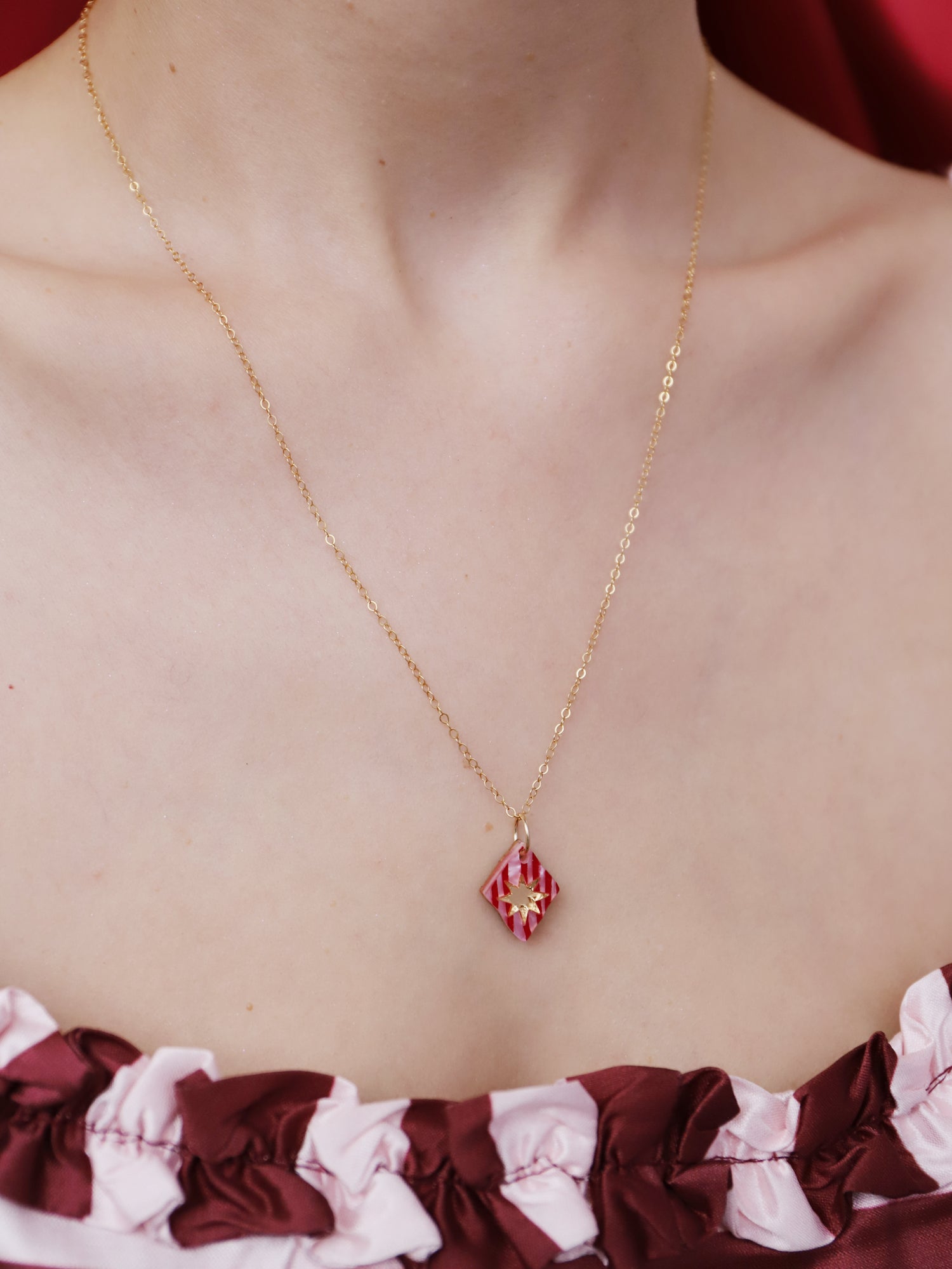 Nova Necklace in Rose on a model, showcasing gold-filled chain and intricate acrylic design, handmade in UK by Wolf & Moon.