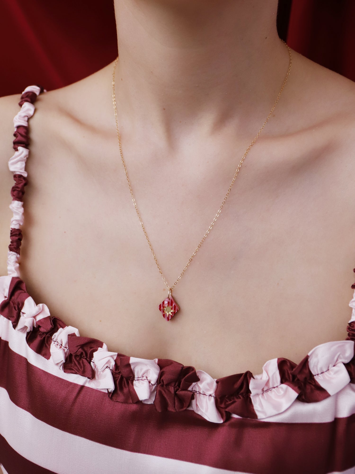 Nova Necklace in Rose worn by a model, showcasing its intricate design and gold-filled chain, handmade in UK by Wolf & Moon.