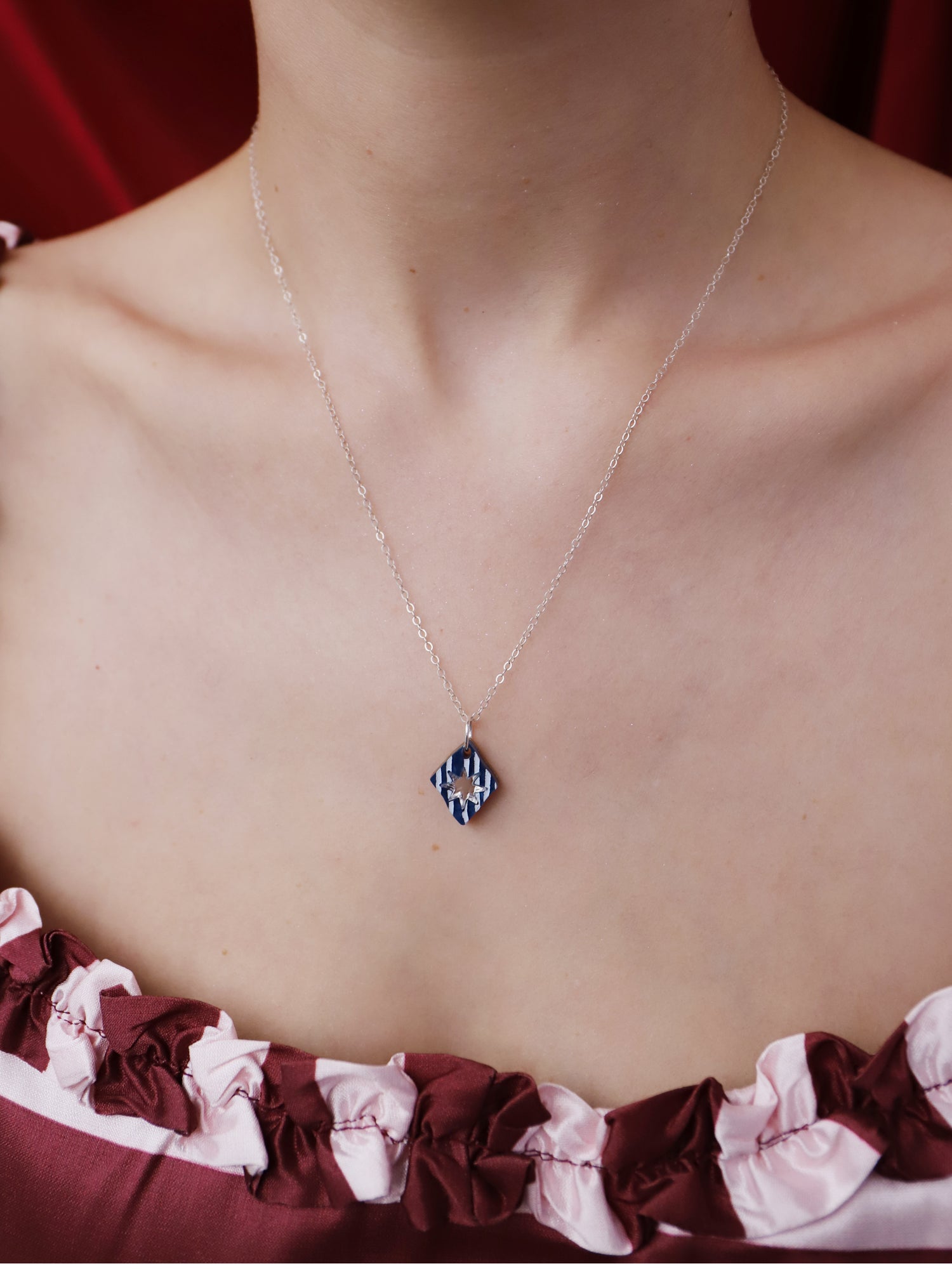 Nova Necklace in Sapphire worn on model, showcasing unique design and lightweight materials, Handmade in UK by Wolf & Moon.