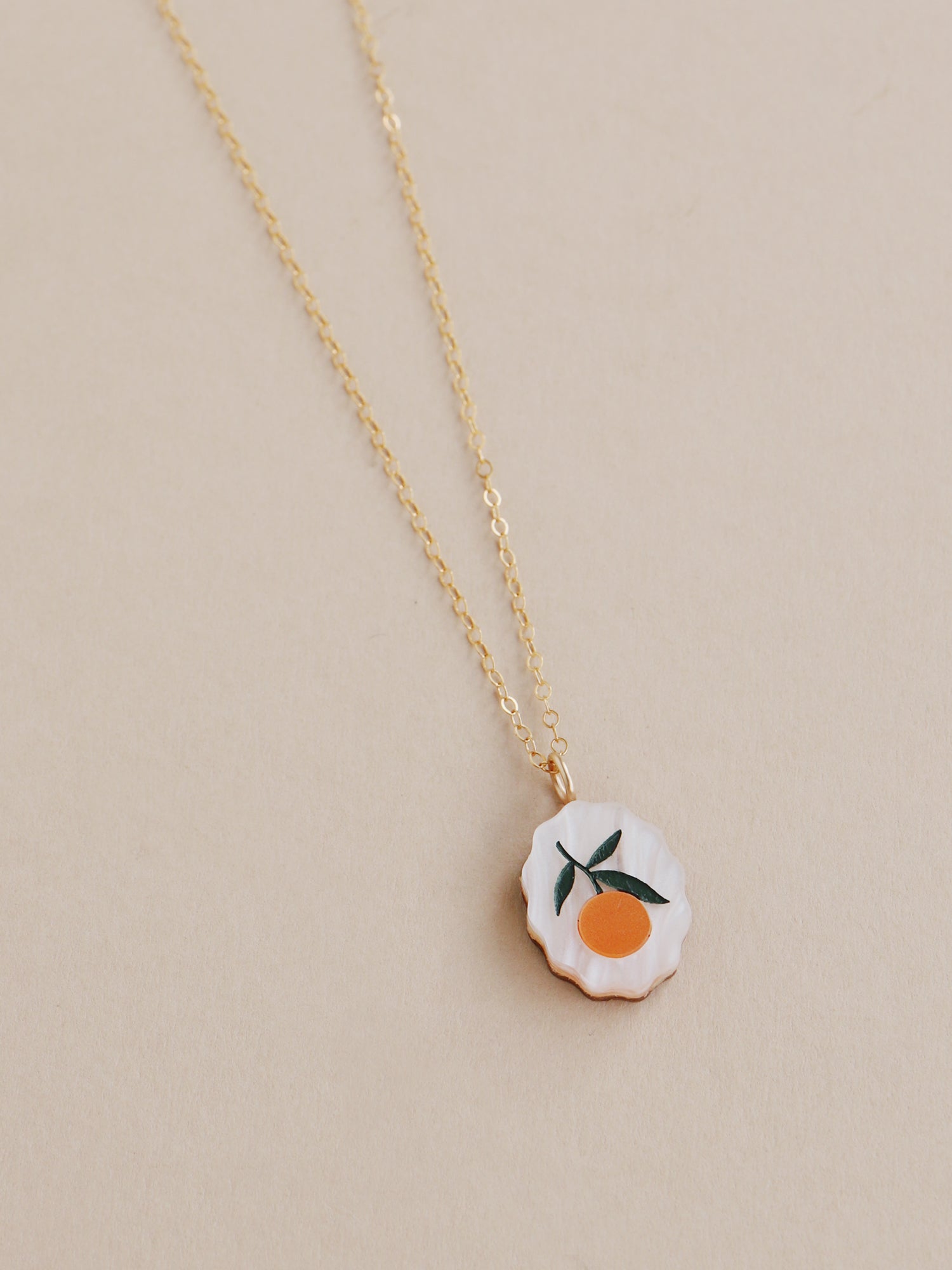 Orange charm necklace made from acrylic and a 14k gold-filled chain & findings. Handmade in the UK by Wolf & Moon