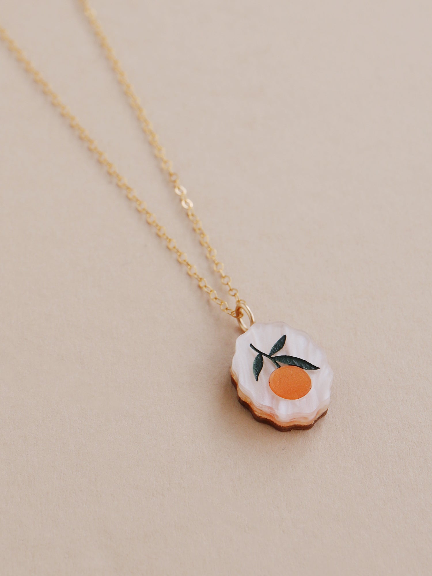 Orange charm necklace made from acrylic and a 14k gold-filled chain & findings. Handmade in the UK by Wolf & Moon