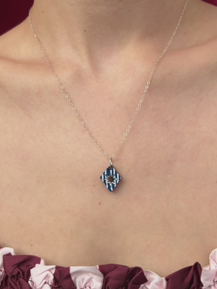 Nova Necklace in Sapphire worn by a model, showcasing its unique design and hand-inked details, handmade in UK by Wolf & Moon.