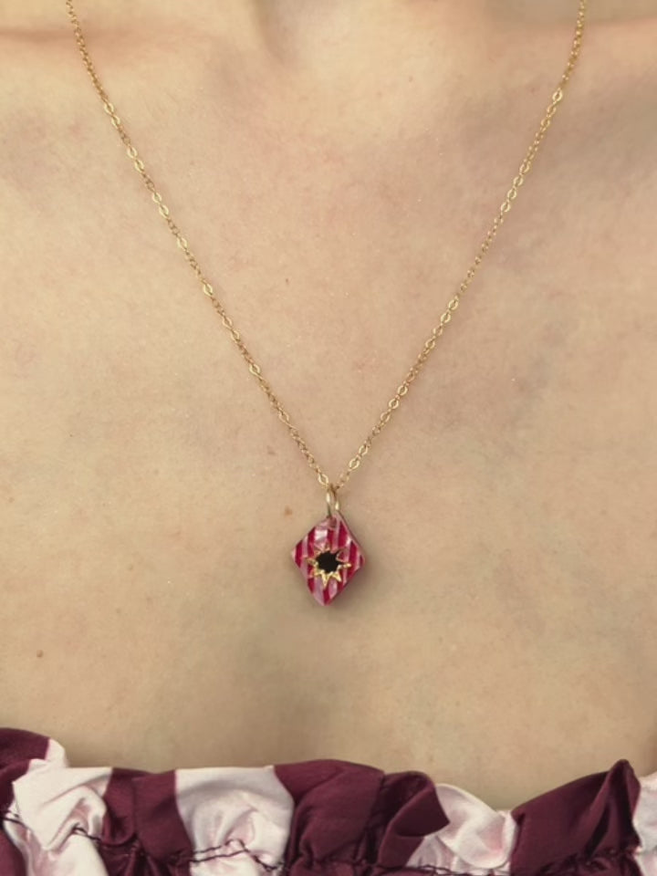 Nova Necklace in Rose showcasing a unique design with intricate details, worn on a model's neck.