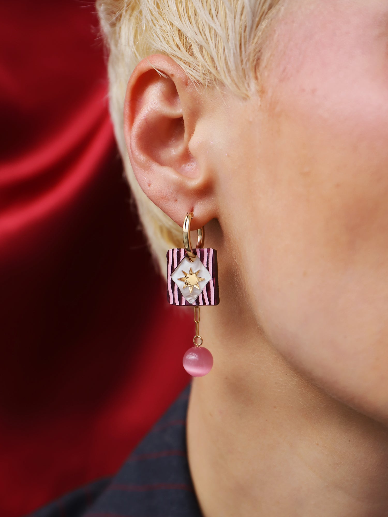 Stella Charm Hoops in Cherry worn by model, showcasing the unique design and vibrant colors, handmade in UK by Wolf & Moon.