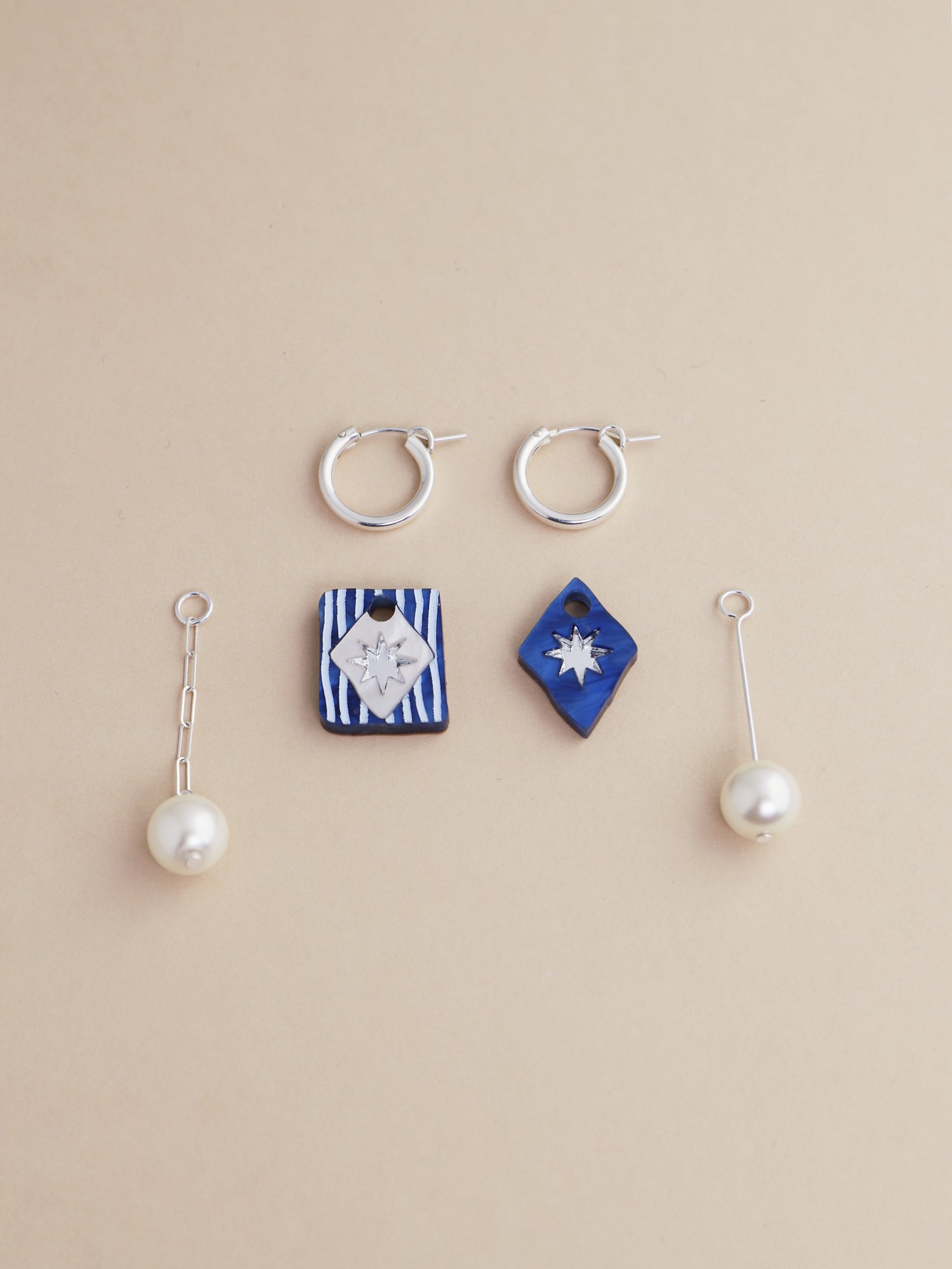 Stella Charm Hoops in Sapphire featuring handmade charms and pearl details, crafted by Wolf & Moon in the UK.