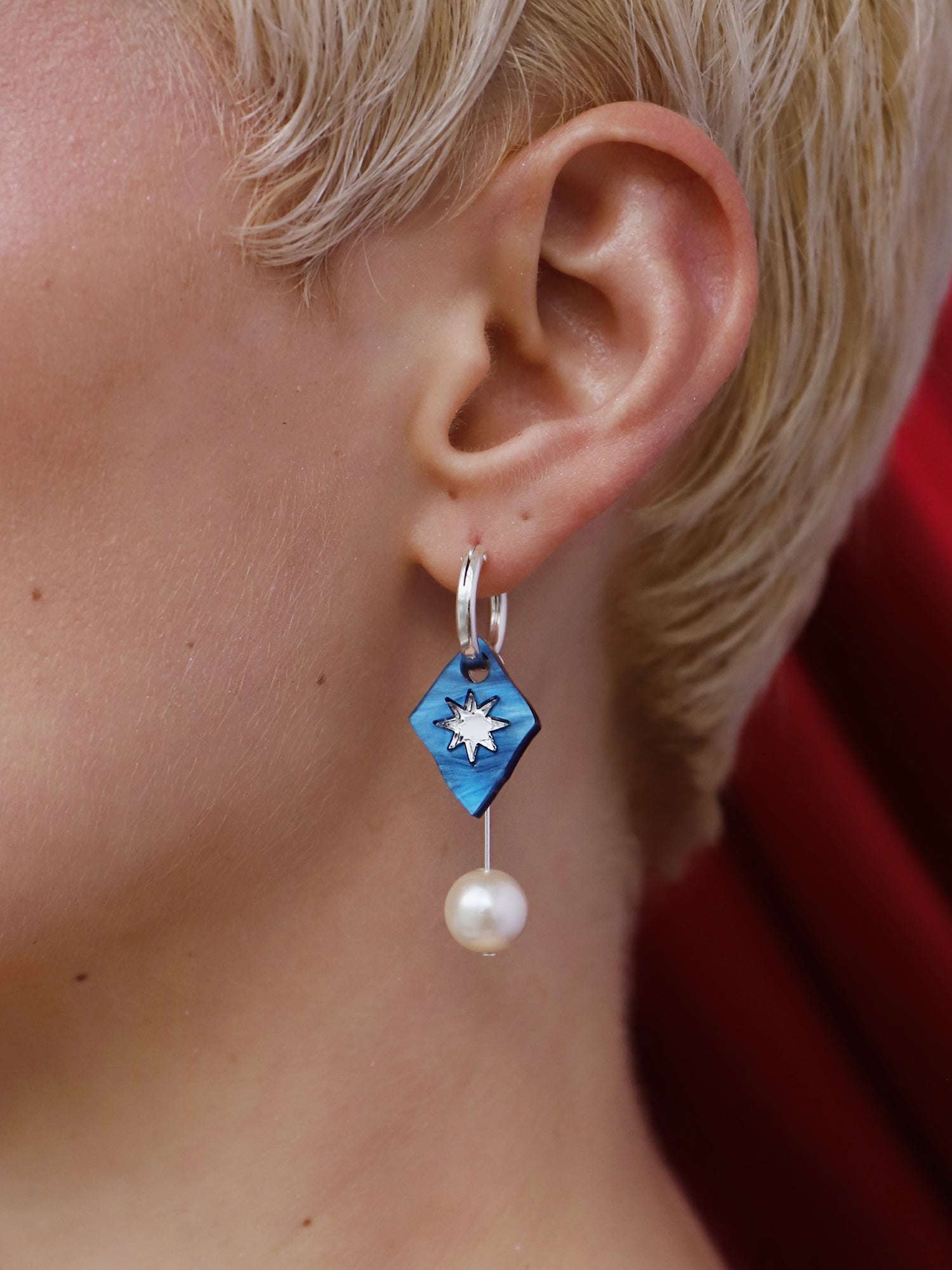 Stella Charm Hoops in Sapphire featuring a hand-inked blue charm and glass pearl detail, handmade in UK by Wolf & Moon.