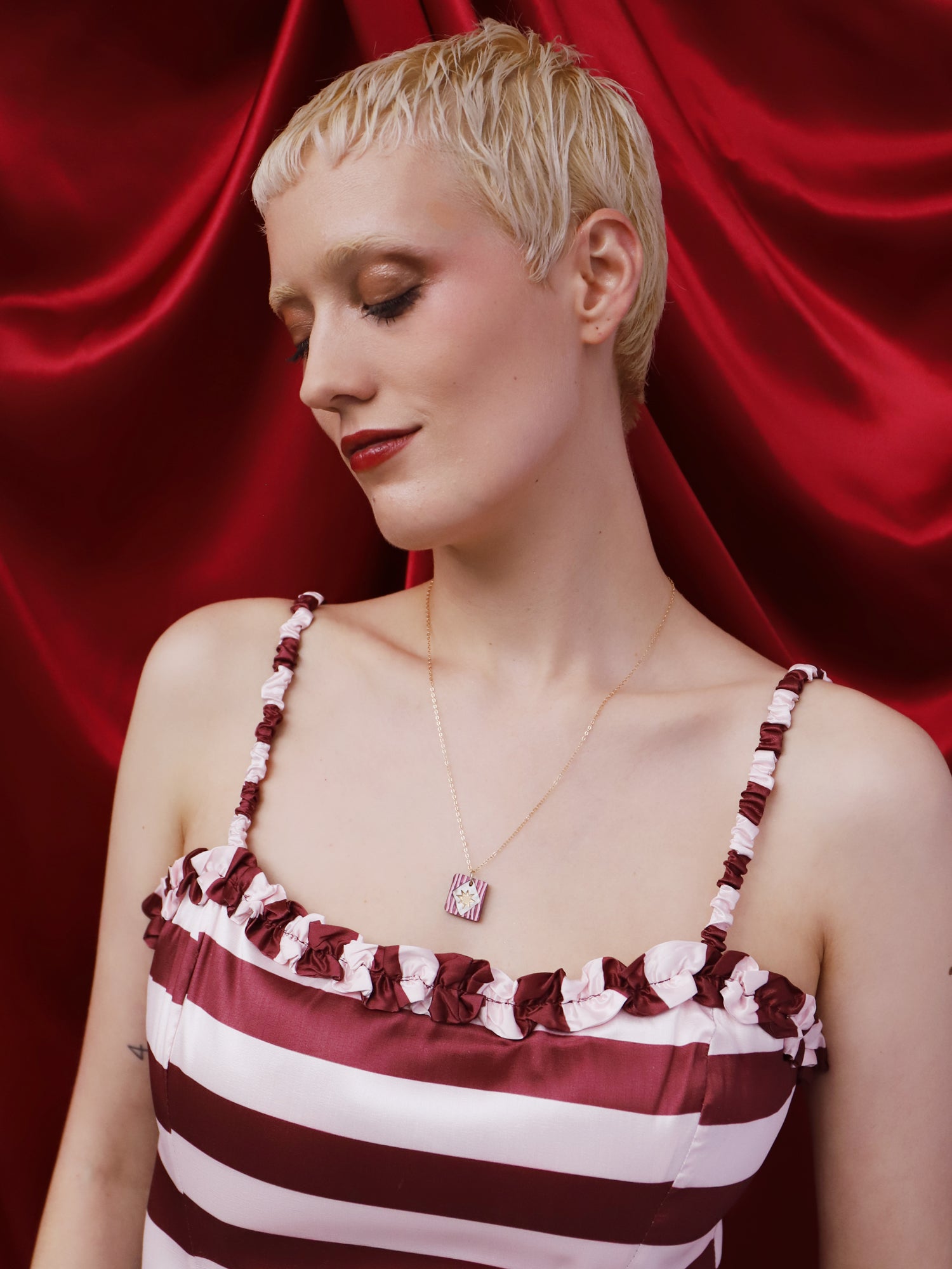 Model wearing Stella Necklace in Cherry, showcasing unique design and lightweight acrylic with gold-filled chain.
