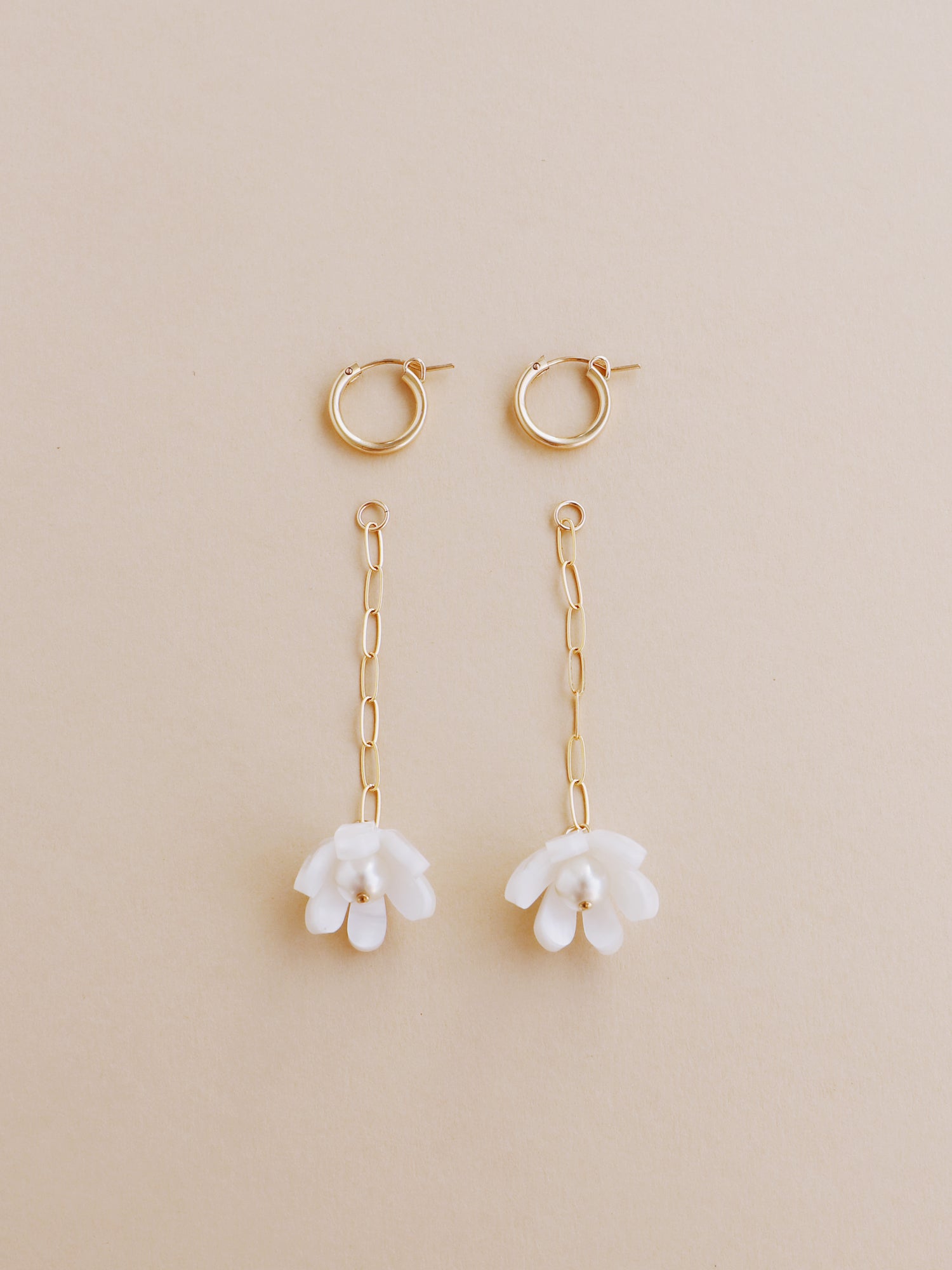 White, sculptural tulip drop hoop earrings. Made from heat-formed acrylic with high quality glass pearls and 14k gold-filled findings. Handmade in the UK by Wolf & Moon
