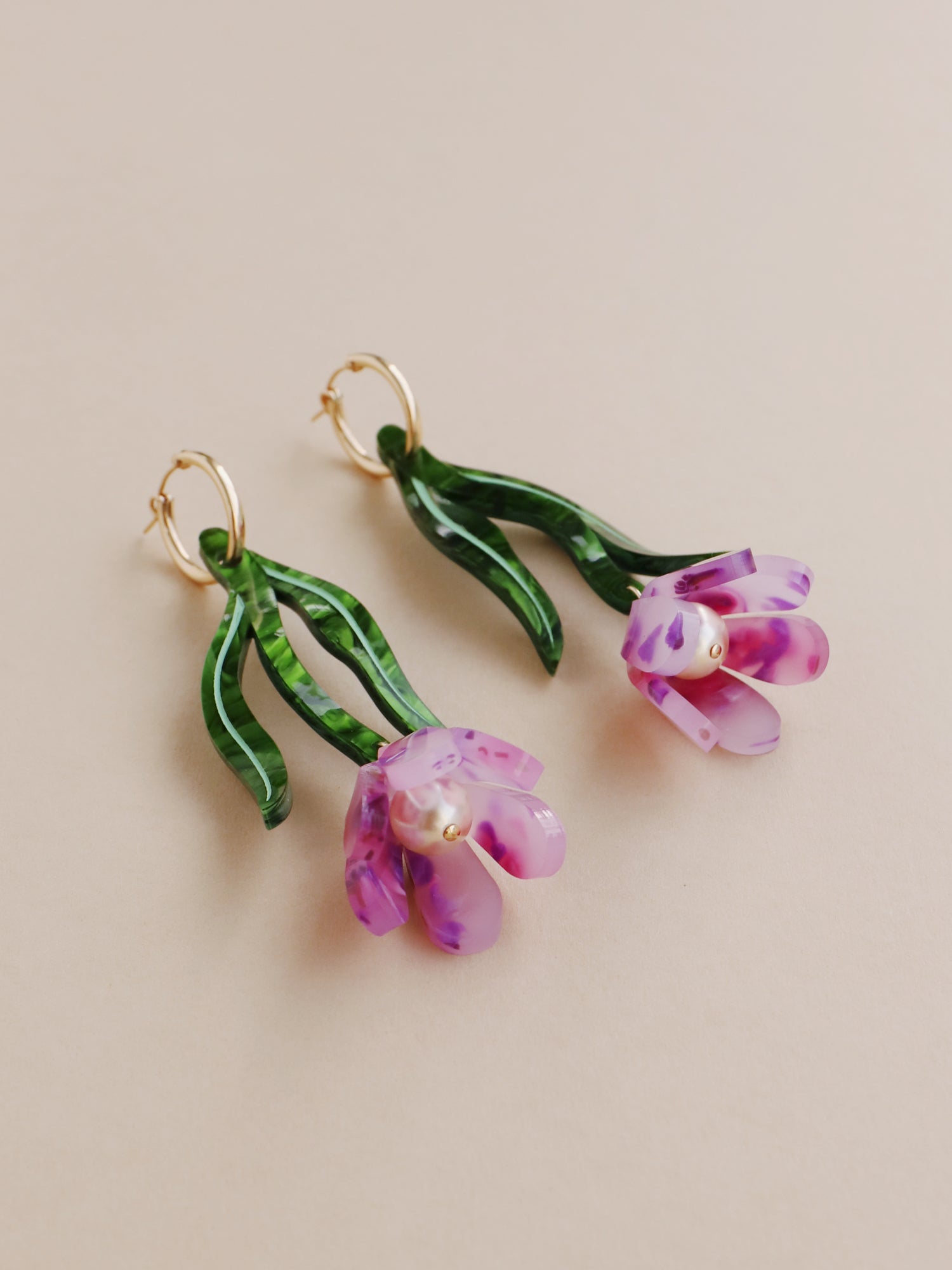 Purple & green sculptural tulip statement hoop earrings. Made from heat-formed acrylic with high quality glass pearls and 14k gold-filled findings. Handmade in the UK by Wolf & Moon.
