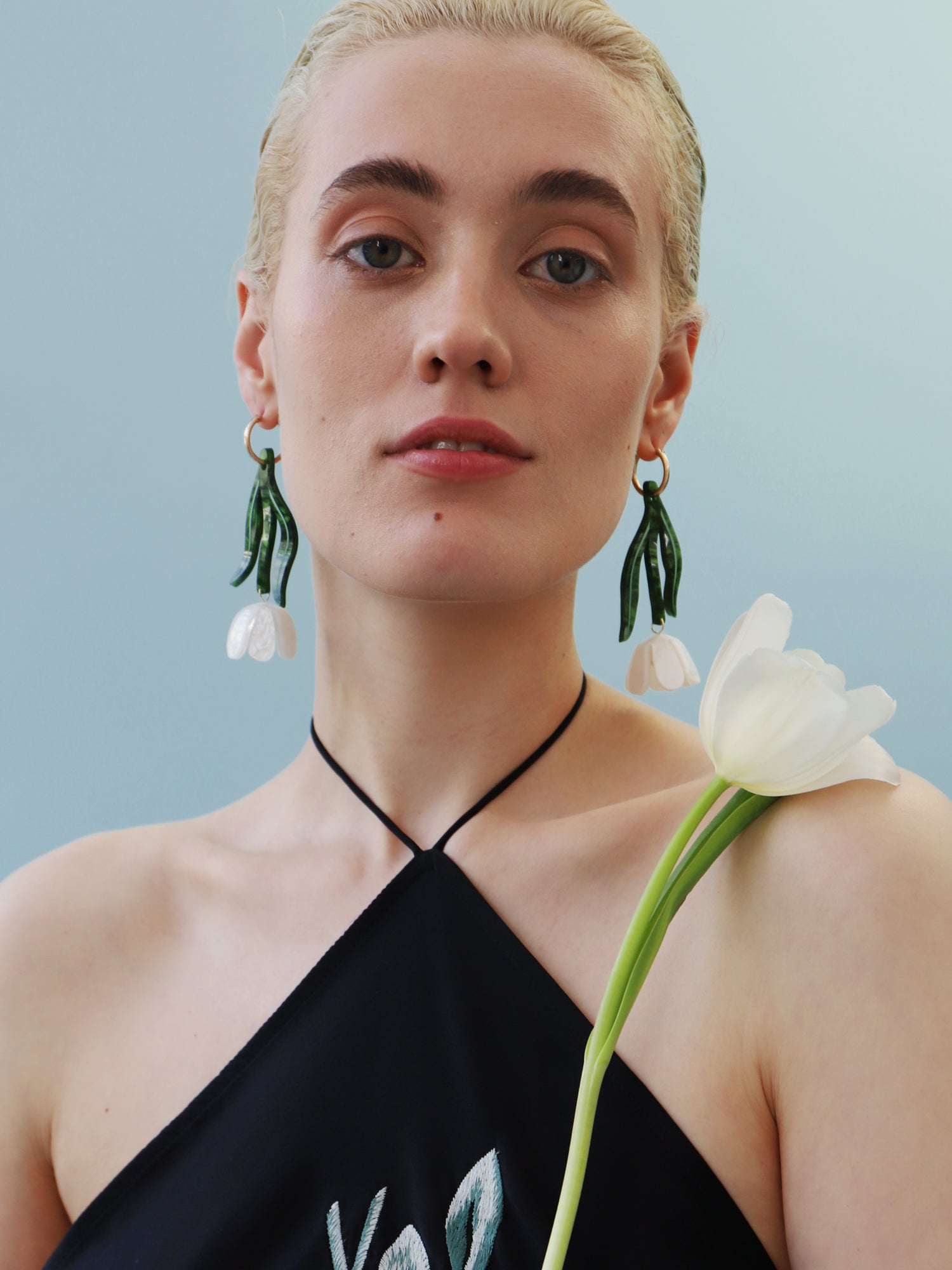 White & green sculptural tulip statement hoop earrings. Made from heat-formed acrylic with high quality glass pearls and 14k gold-filled findings. Handmade in the UK by Wolf & Moon.
