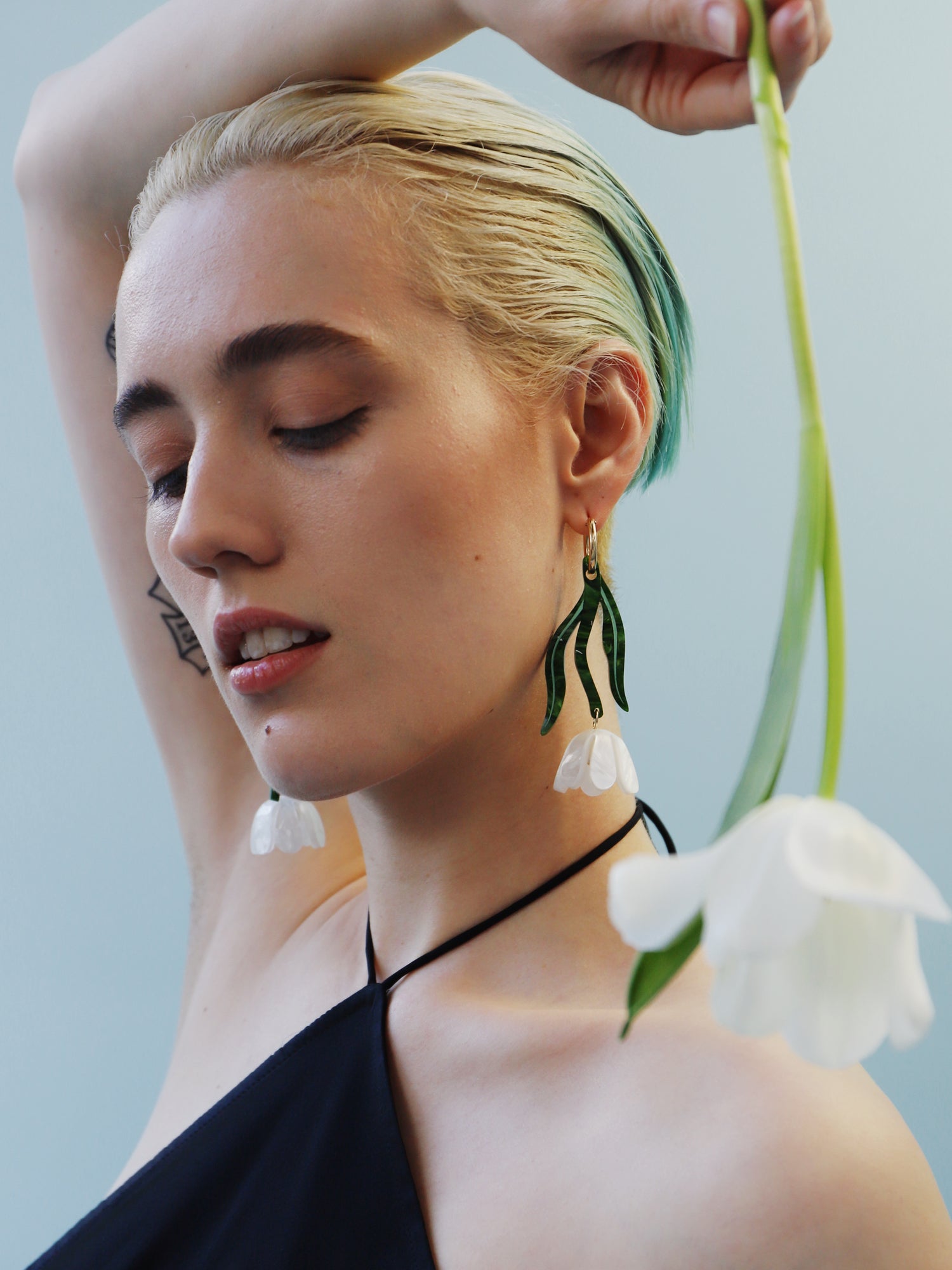 White & green sculptural tulip statement hoop earrings. Made from heat-formed acrylic with high quality glass pearls and 14k gold-filled findings. Handmade in the UK by Wolf & Moon.