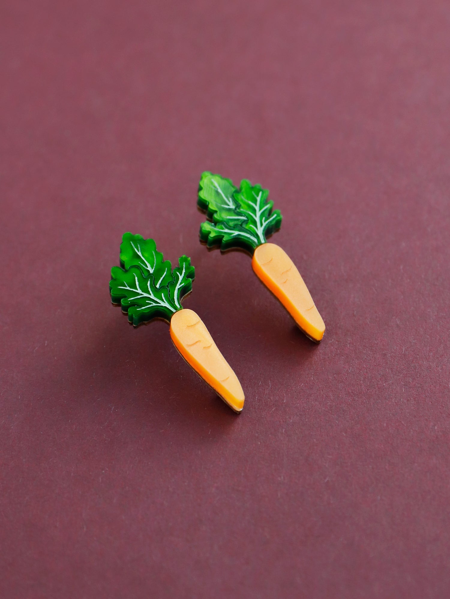 Orange and green carrot stud acrylic earrings with silver posts. Handmade in London by Wolf & Moon.