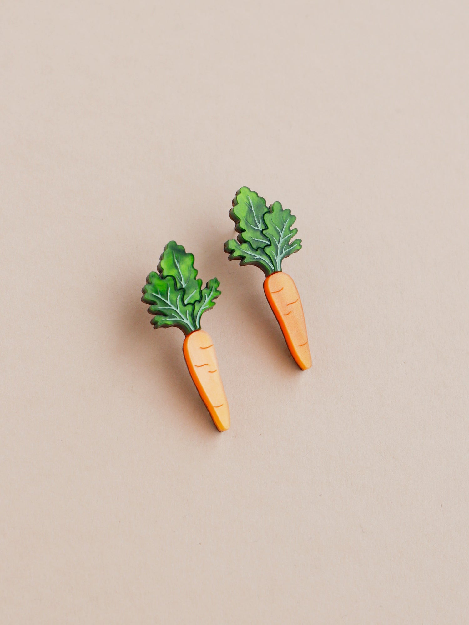 Orange and green carrot stud acrylic earrings with silver posts. Handmade in London by Wolf & Moon.