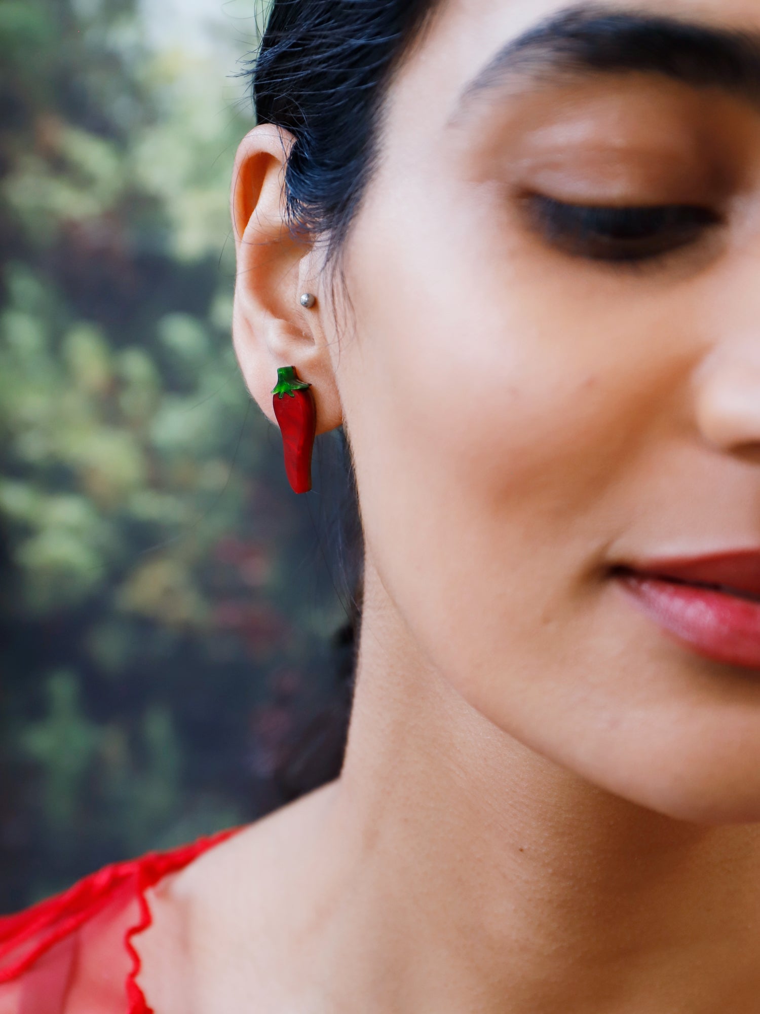 Red chilli pepper acrylic studs with green stalk. Handmade in London by Wolf & Moon.