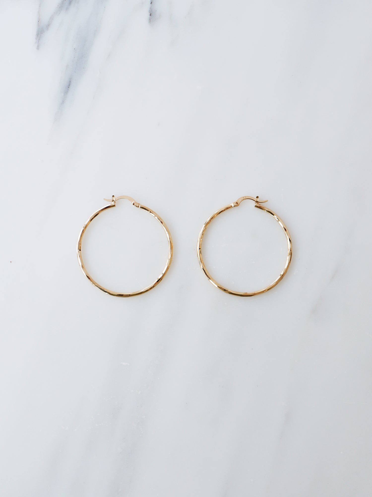 40mm hoops are made from solid brass with a very high quality 3-micron 24k gold-plating. Handmade in France, available from Wolf & Moon. 