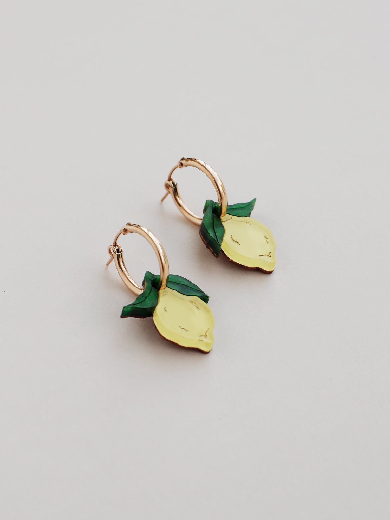Lemon hoops made with wood, 64% recycled acrylic and hand-inked details with sterling silver earring posts & butterflies. Handmade in the UK at Wolf & Moon.