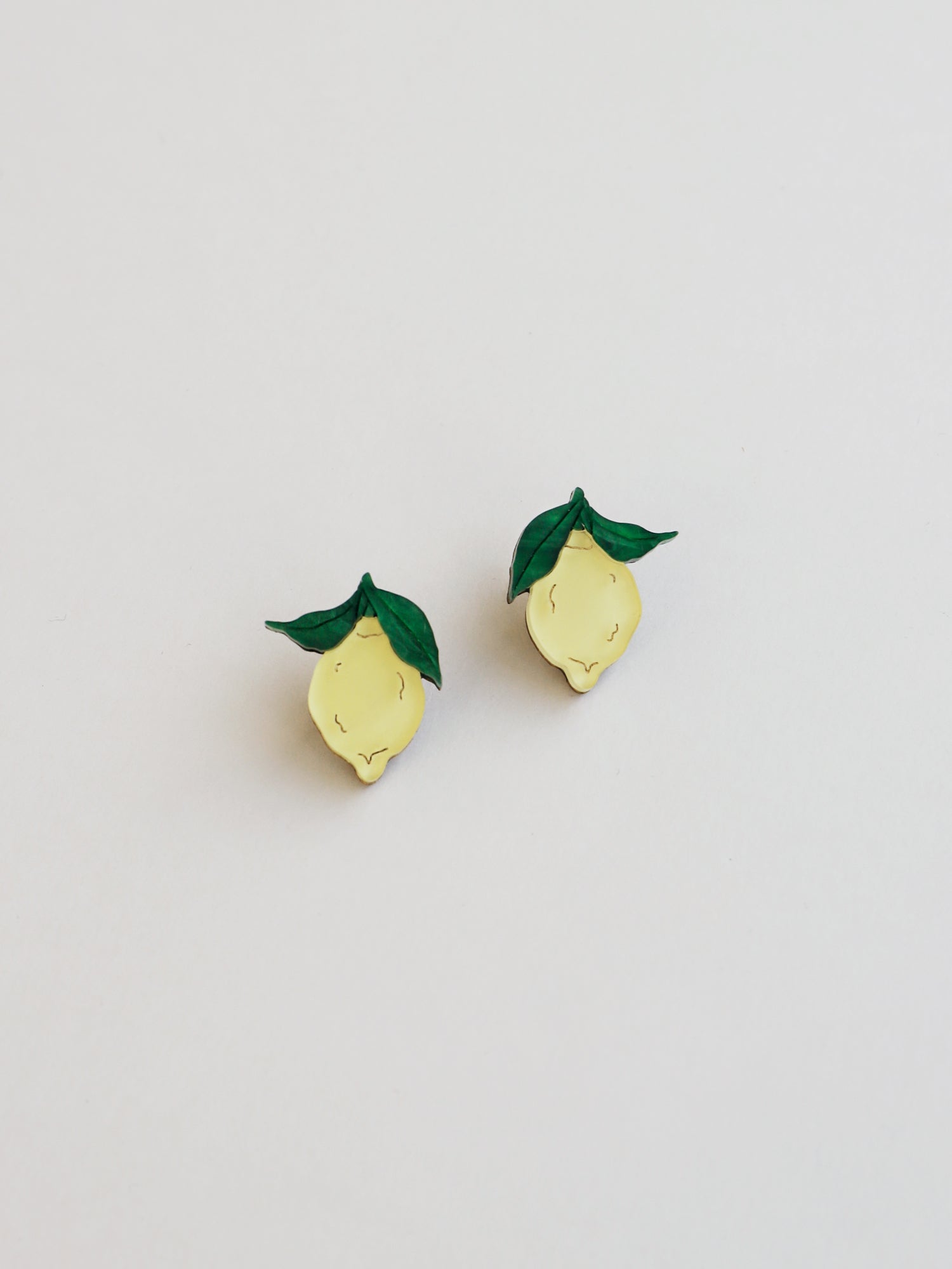 Lemon studs made with wood, 64% recycled acrylic and hand-inked details with sterling silver earring posts & butterflies. Handmade in the UK at Wolf & Moon.