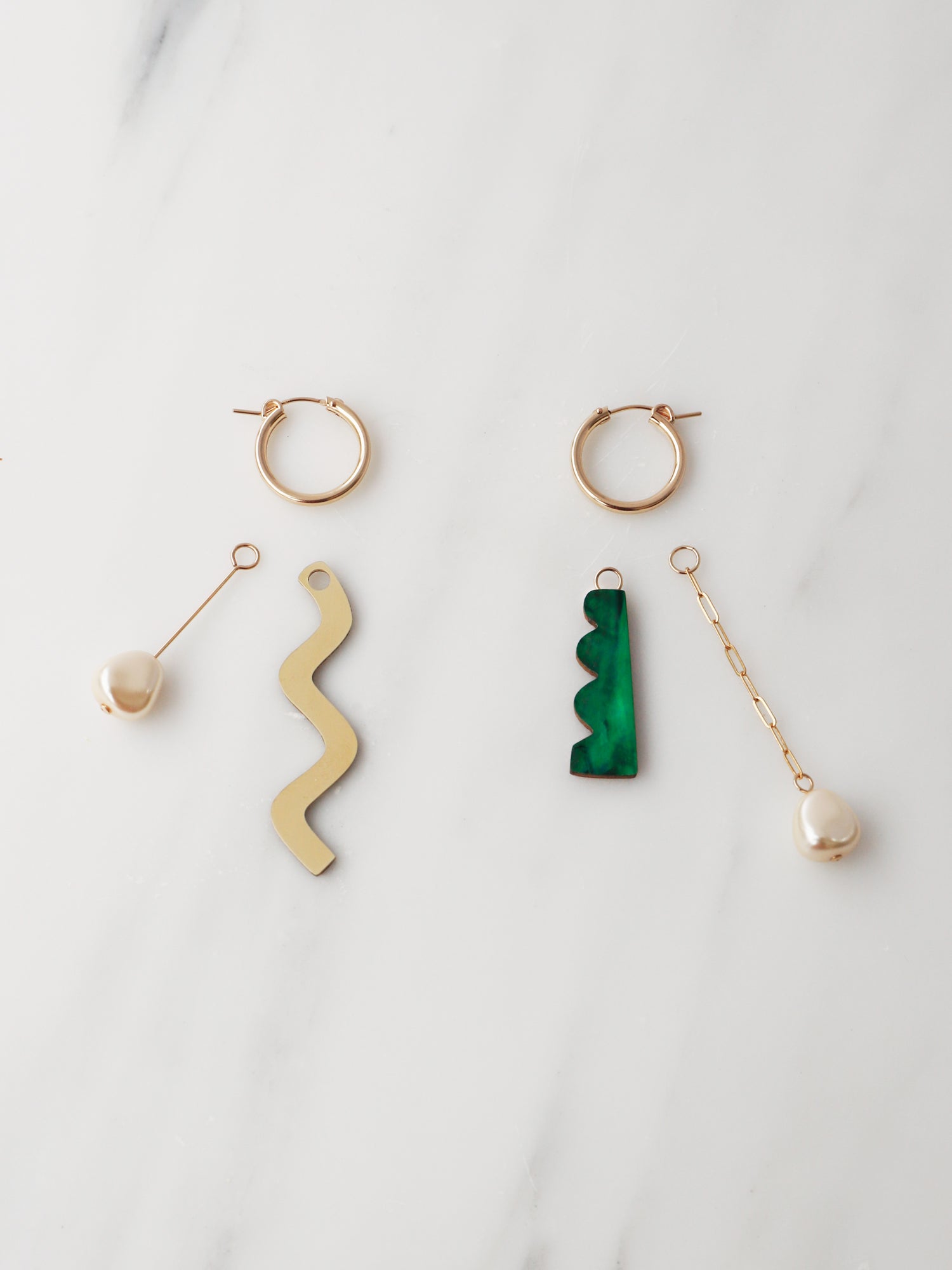 Martha Charm Hoops in Emerald. Playful hoop earrings with four interchangeable charms that can be worn individually or layered up in any combination. 14k gold-filled hoops. Handmade in the UK by Wolf & Moon.
