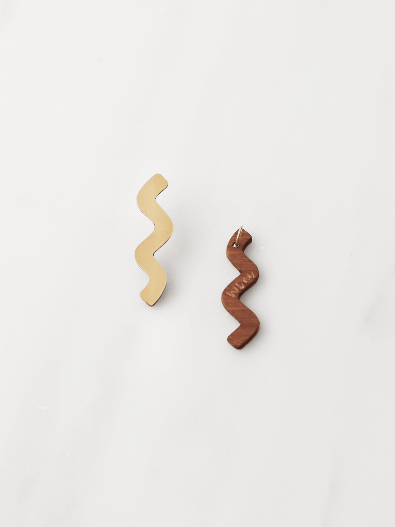 Playful wavy studs in brass with our signature wooden back and sterling silver earring posts. Handmade in the UK by Wolf & Moon.