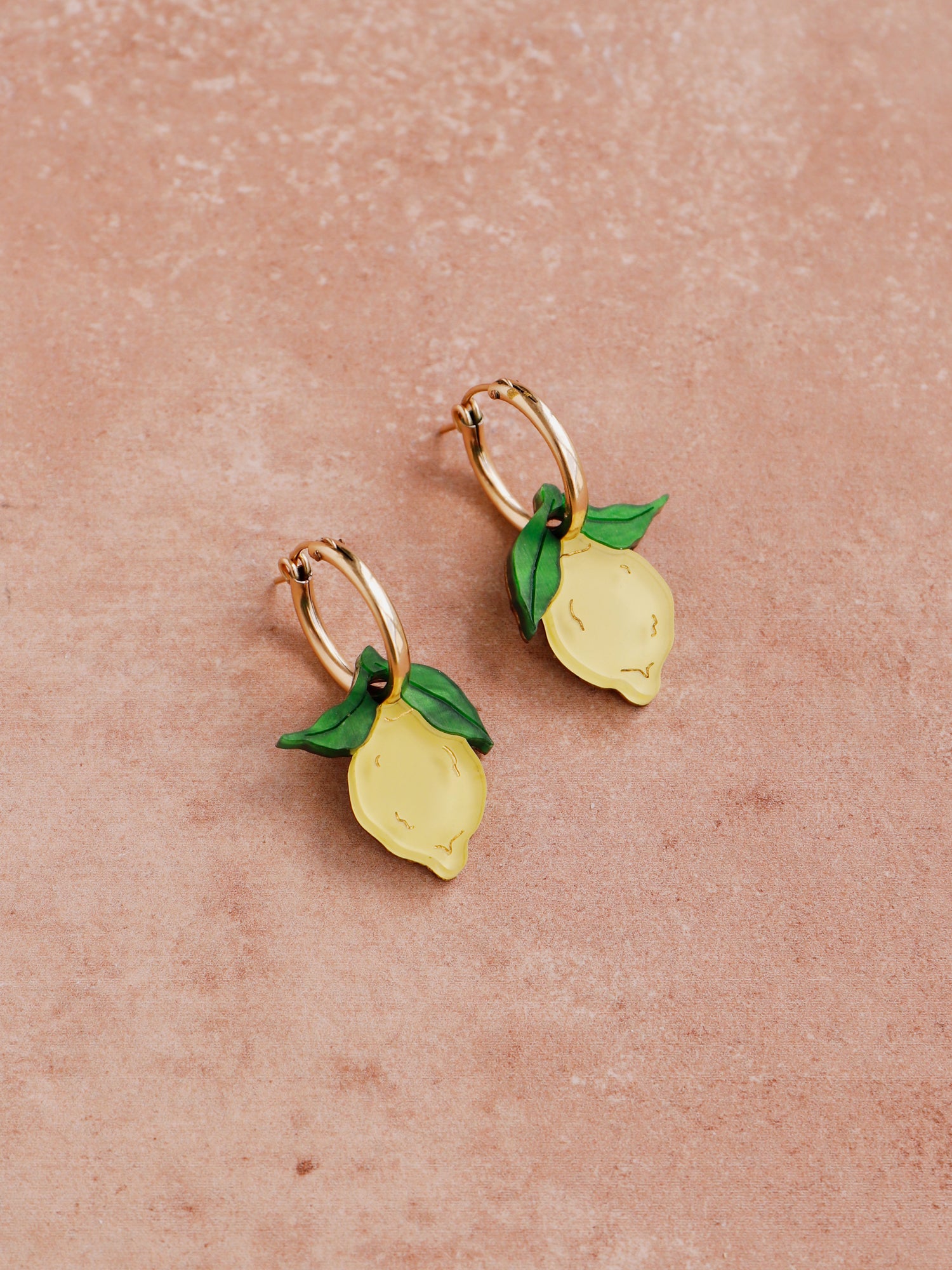 Lemon hoops made with wood, 64% recycled acrylic and hand-inked details with sterling silver earring posts & butterflies. Handmade in the UK at Wolf & Moon.