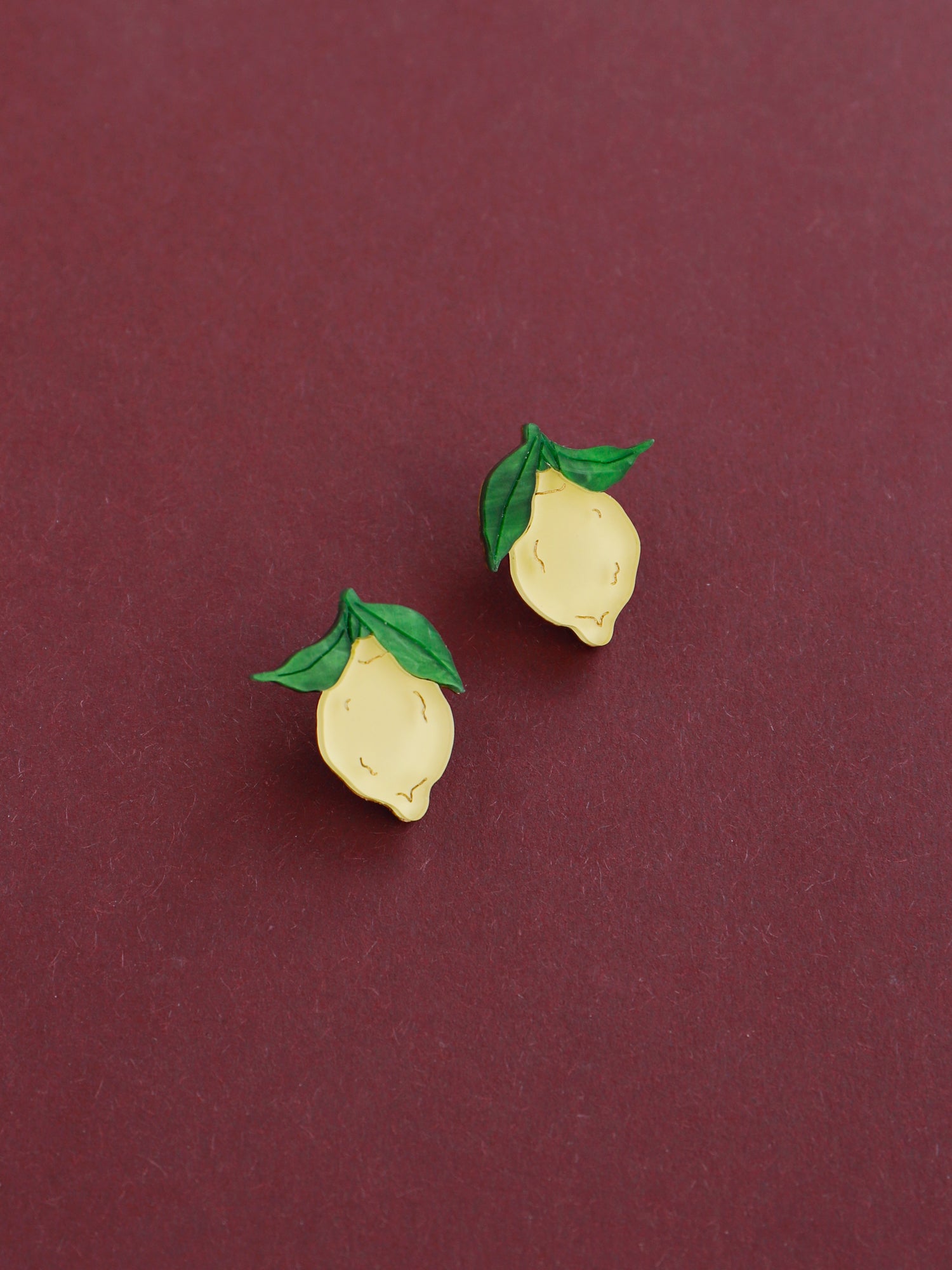 Lemon studs made with wood, 64% recycled acrylic and hand-inked details with sterling silver earring posts & butterflies. Handmade in the UK at Wolf & Moon.