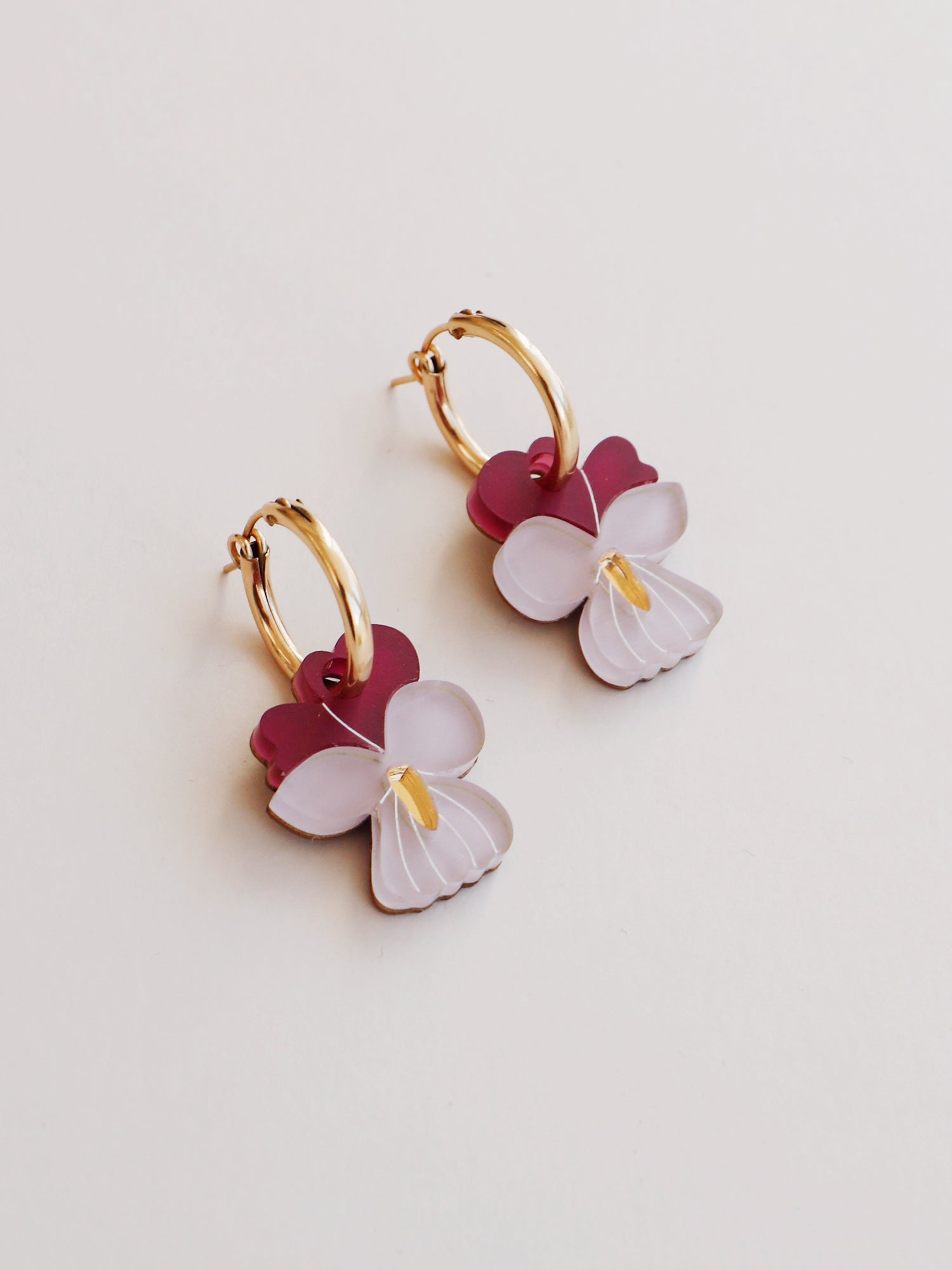 Violet hoop earrings made with wood, 64% recycled acrylic and hand-inked details on 14k gold-filled hoops (optional). Handmade in the UK by Wolf & Moon.