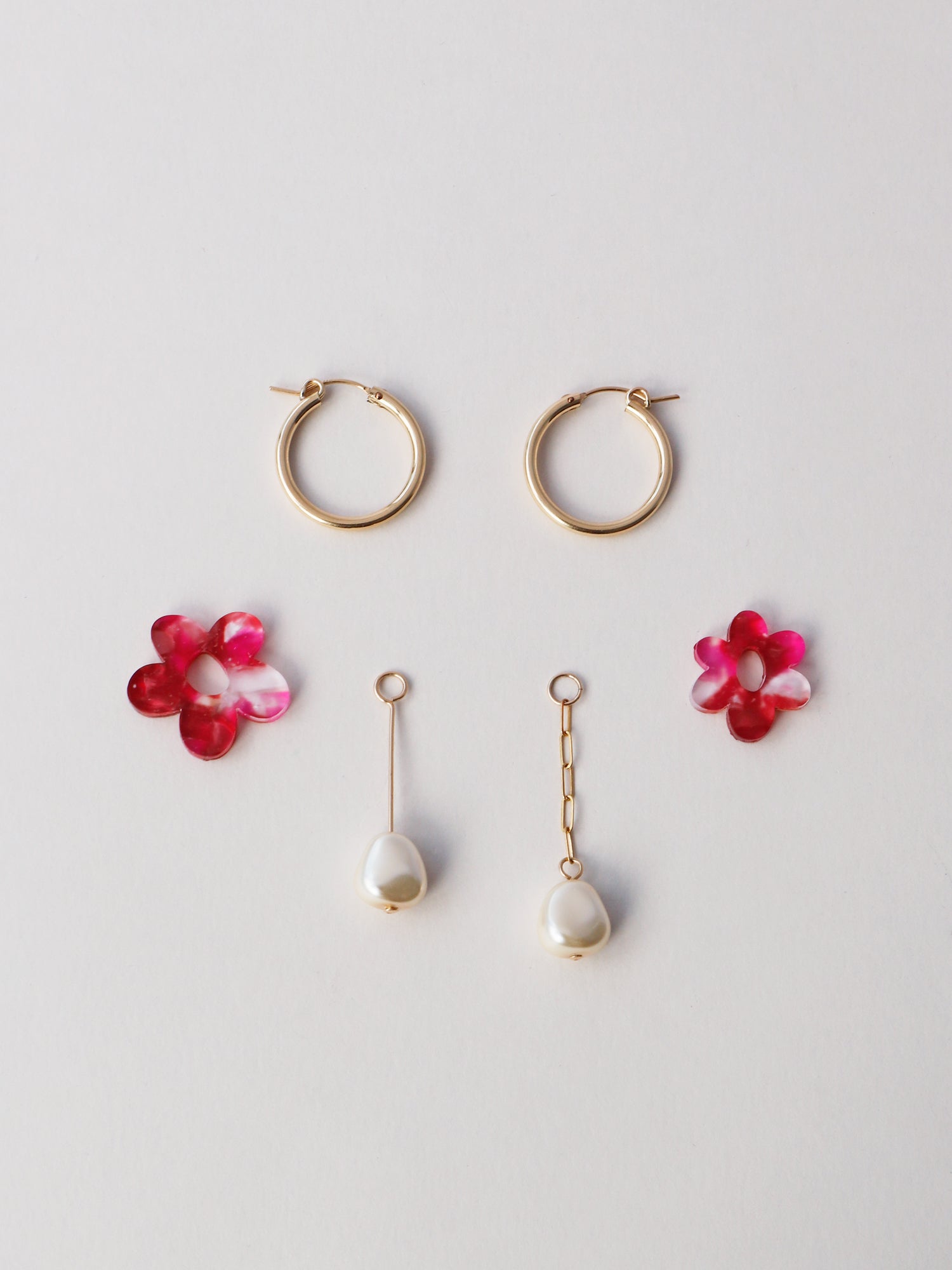 Nina Charm Hoops in Raspberry Crush. 4 individual charms made using 100% recycled, semi-transparent, pink acrylic with a brushed matt finish and faux pearls. Handmade in the UK by Wolf & Moon. 