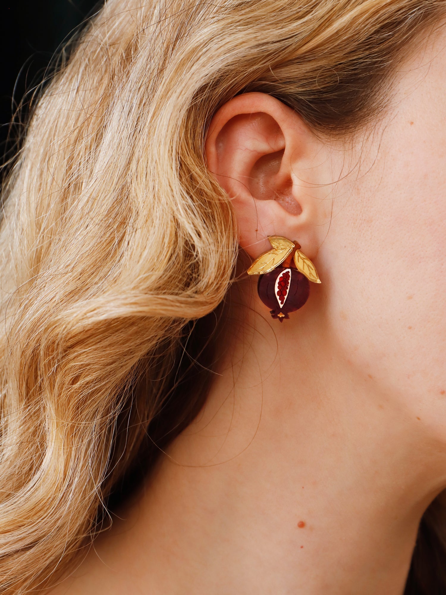 Pomegranate stud clip-on earrings made with wood, acrylic and hand-inked details. Handmade in the UK by Wolf & Moon.