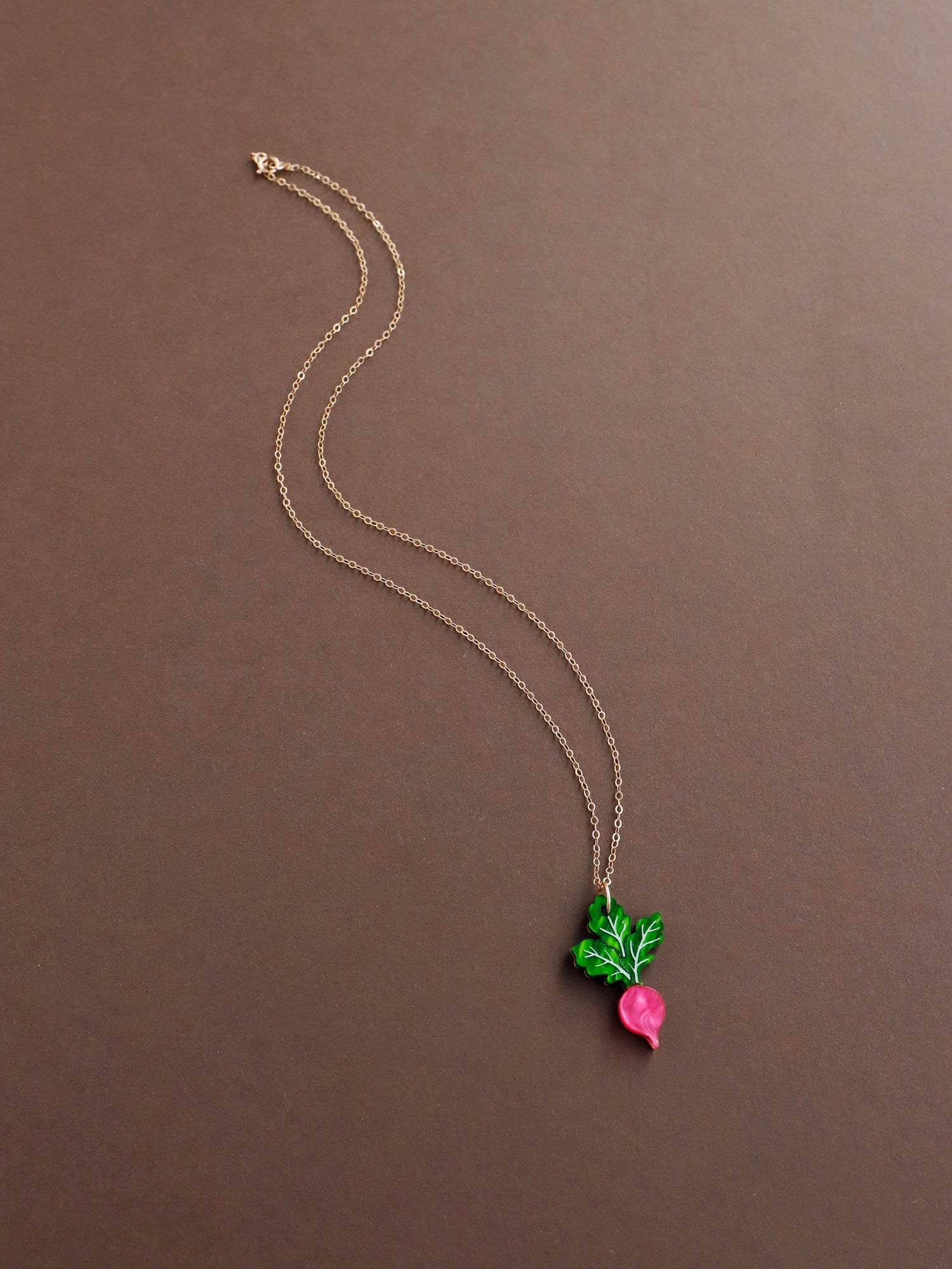 Pink and green mini acrylic radish pendant necklace with optional gold-filled chain. Handmade in London by Wolf & Moon.