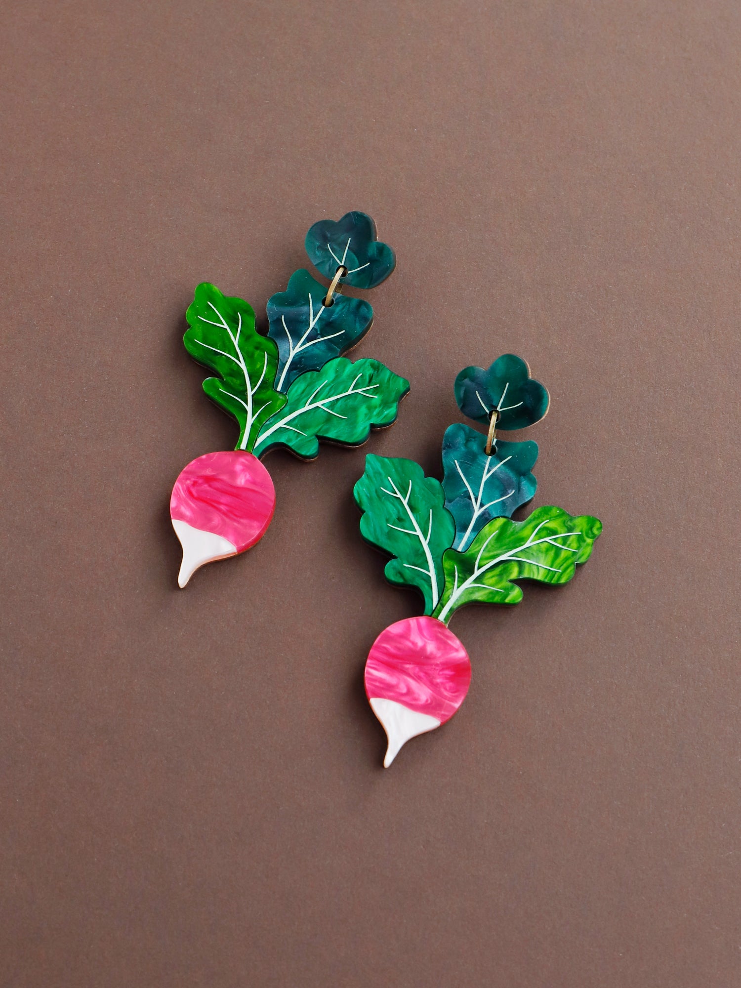 Statement red and green radish acrylic earrings. Handmade in London by Wolf & Moon.