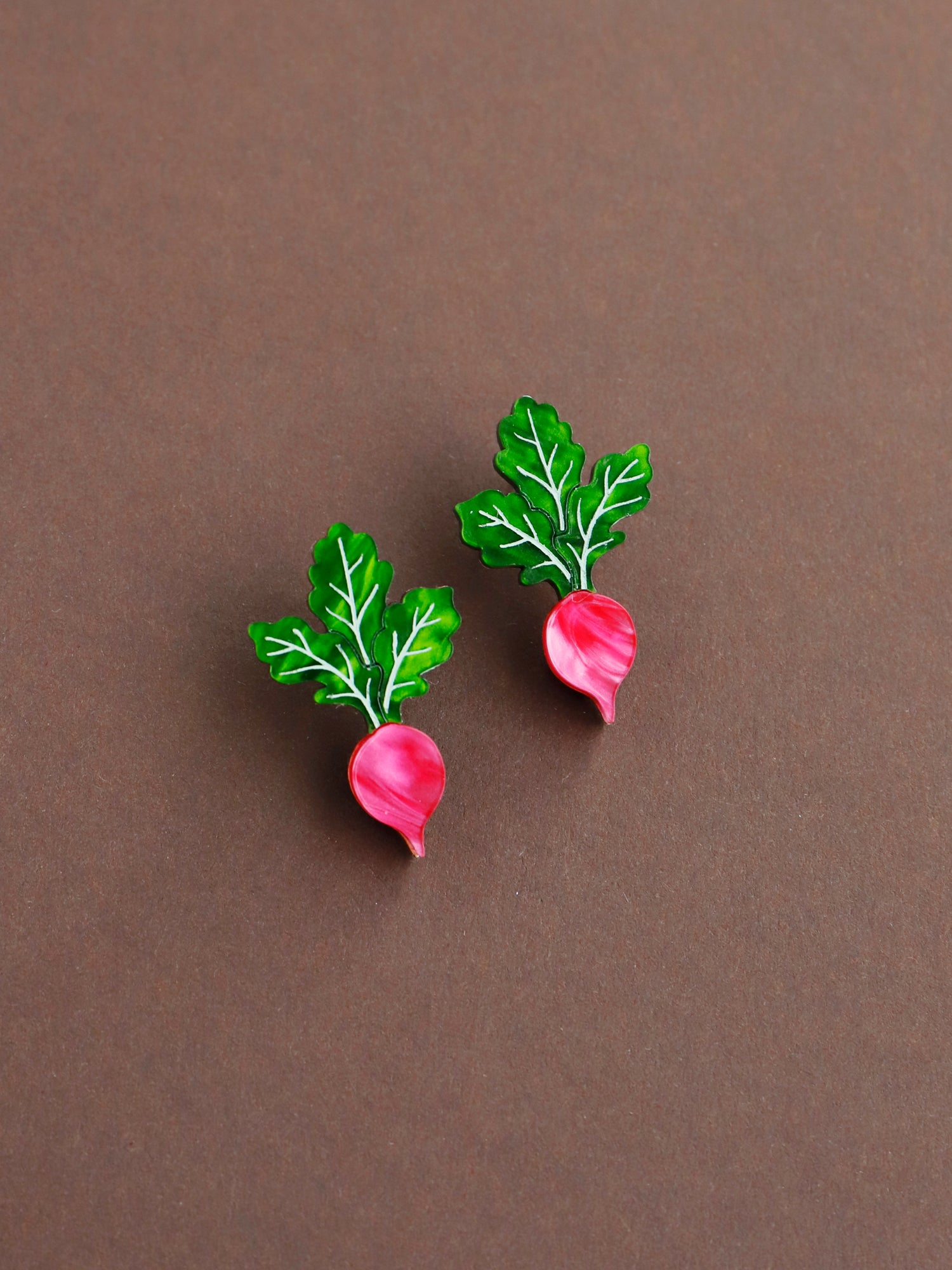 Pink and green acrylic mini radish stud earrings with silver clip on clasps. Handmade in London by Wolf & Moon. 