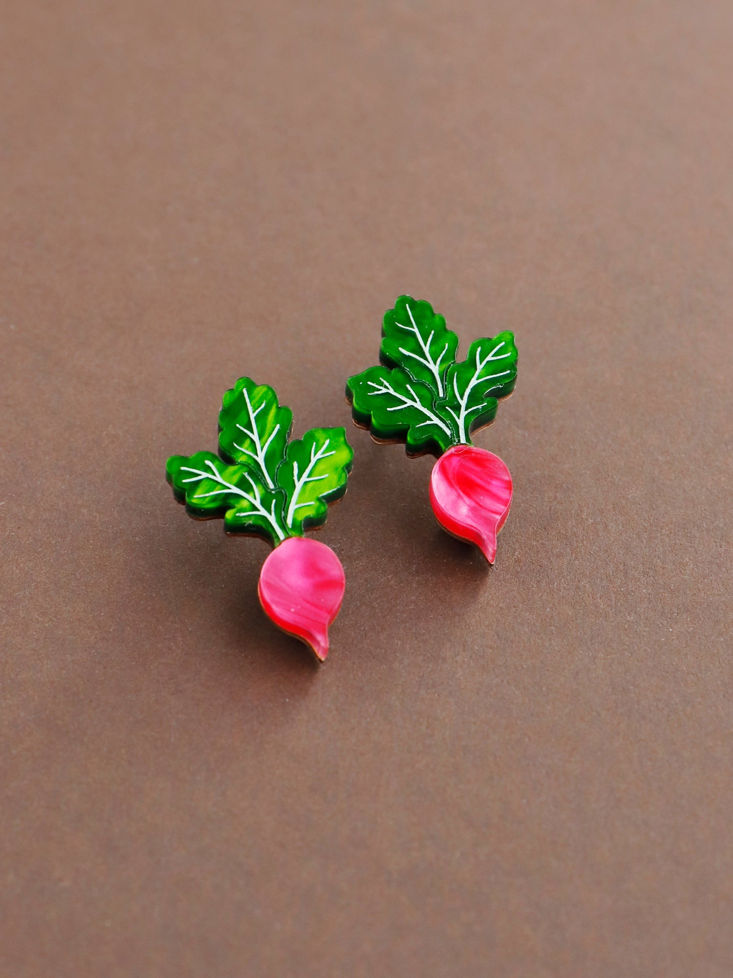 Pink and green acrylic mini radish stud earrings with silver posts. Handmade in London by Wolf & Moon.