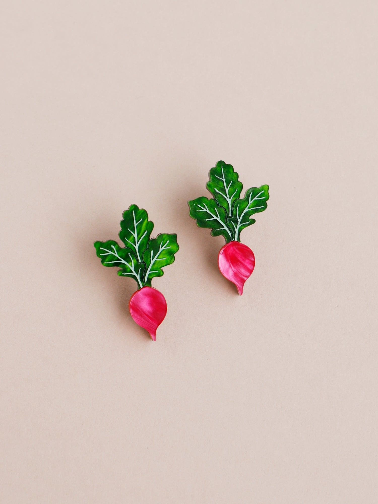 Pink and green acrylic mini radish stud earrings with silver clip on clasps. Handmade in London by Wolf & Moon.
