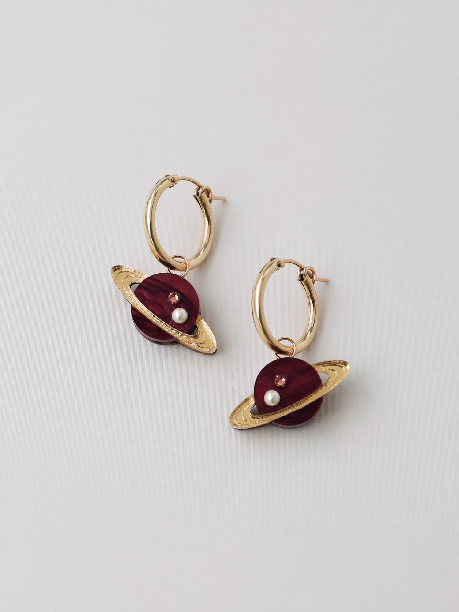 Saturn charm hoops in pearlescent cherry acrylic, embellished with high quality glass pearls & crystals. Wear with our gold-filled hoops. Handmade in London by Wolf & Moon.
