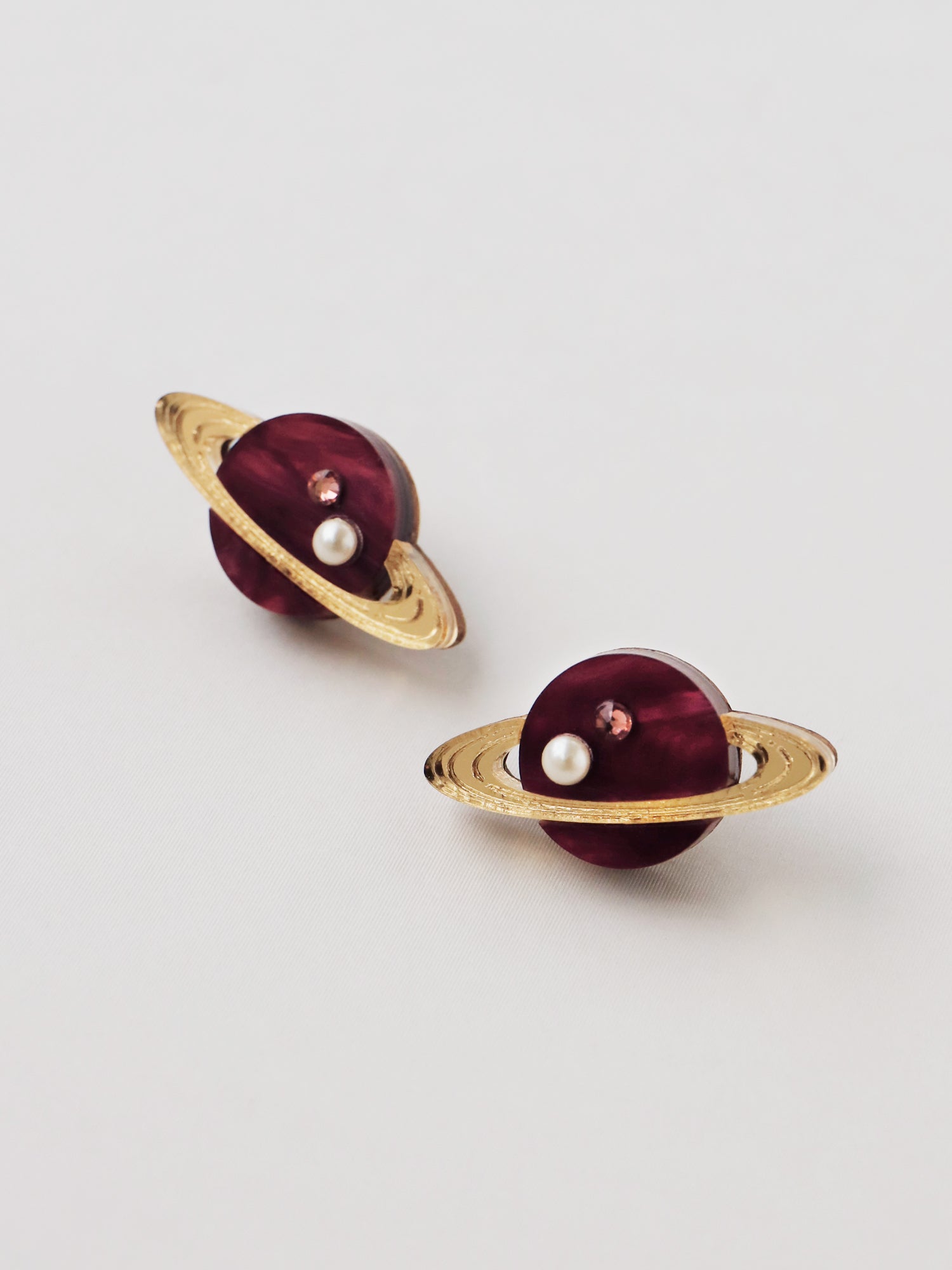 Saturn studs in pearlescent cherry acrylic, embellished with high quality glass pearls & crystals. Handmade in London by Wolf & Moon.